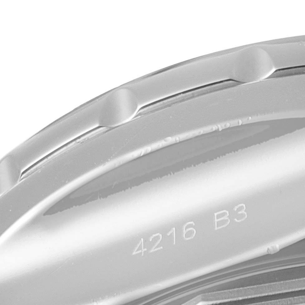 The image shows a close-up view of the bezel and edge of the case back of a Bentley model by Breitling, with partial engravings visible.