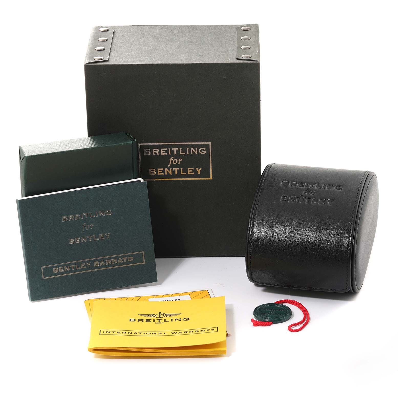 The image shows the packaging, booklet, warranty cards, and a leather case for a Breitling for Bentley watch model.