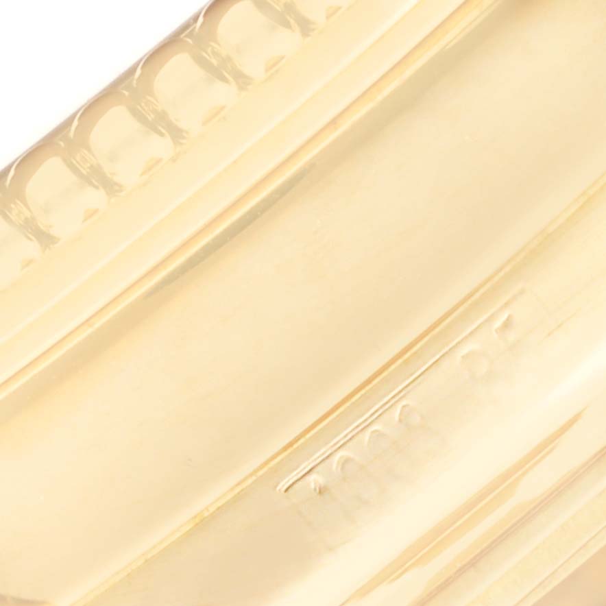 This close-up image shows the side and edge details of the bezel on a Breitling Navitimer K35330 Men's Yellow Gold Silver Dial K35330 Men's Yellow Gold Silver Dial watch.