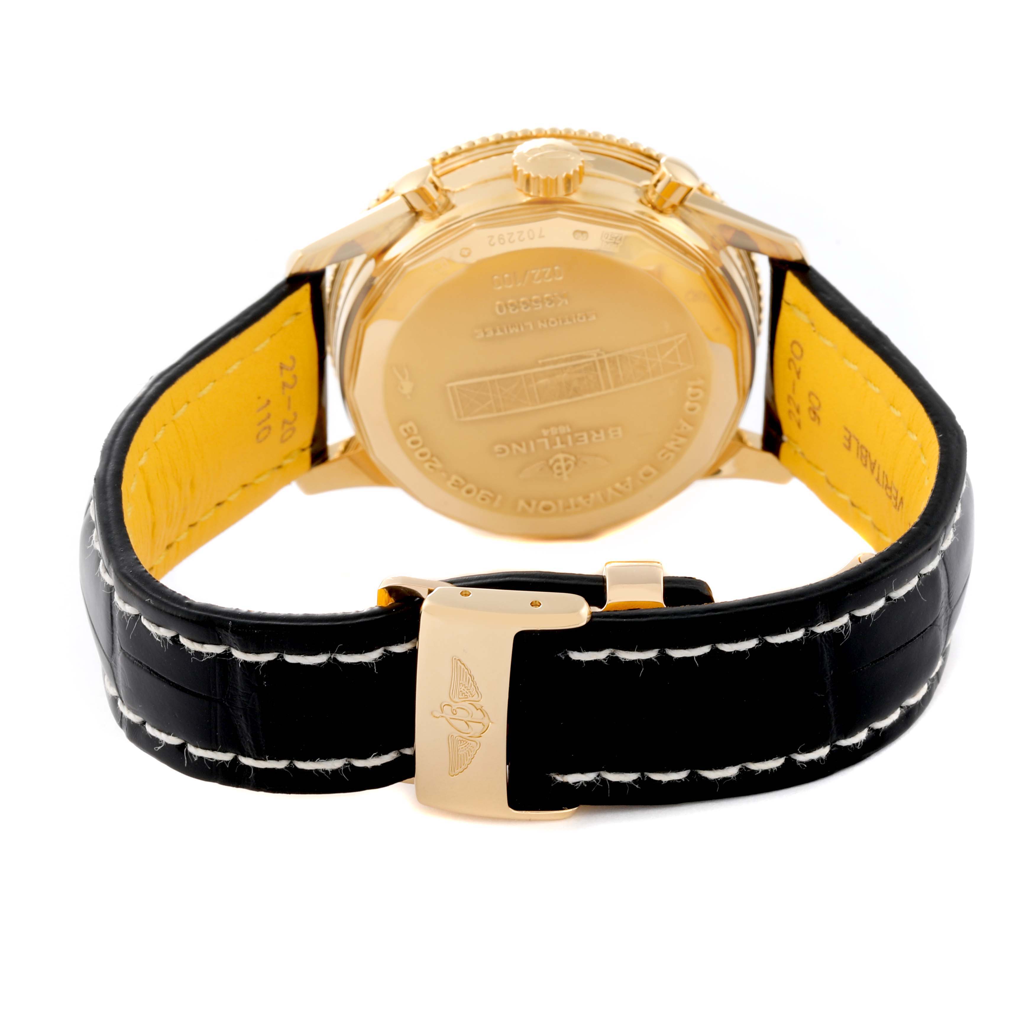 This image shows the backside and clasp of a Breitling Navitimer K35330 Men's Yellow Gold Silver Dial K35330 Men's Yellow Gold Silver Dial watch with a black leather strap and gold case.