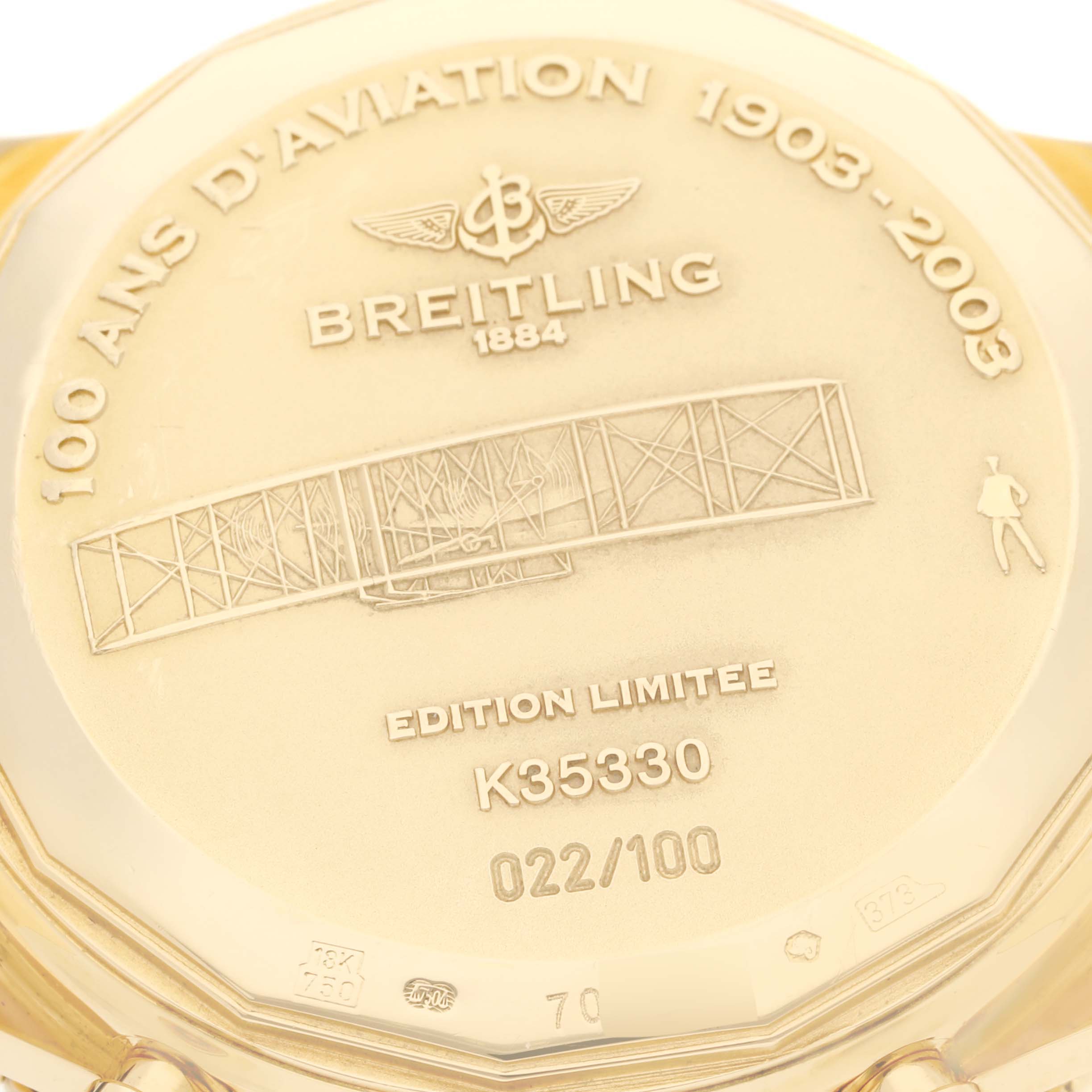 This image shows the case back of a Breitling Navitimer K35330 Men's Yellow Gold Silver Dial K35330 Men's Yellow Gold Silver Dial watch, featuring an engraving for the 100th anniversary of aviation.