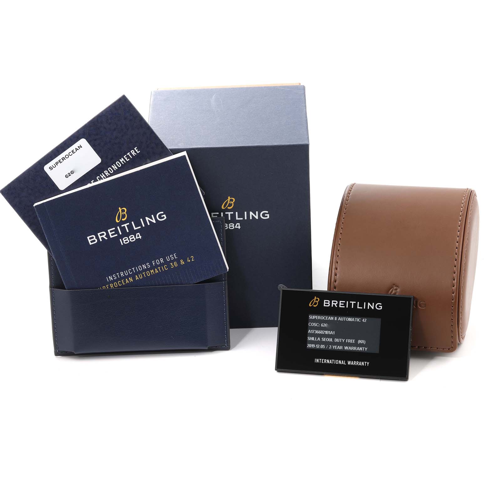 This image shows accessories for the Breitling Superocean A17366 Men's Stainless Steel Black Dial A17366 Men's Stainless Steel Black Dial watch, including manuals, warranty card, packaging box, and a leather case.
