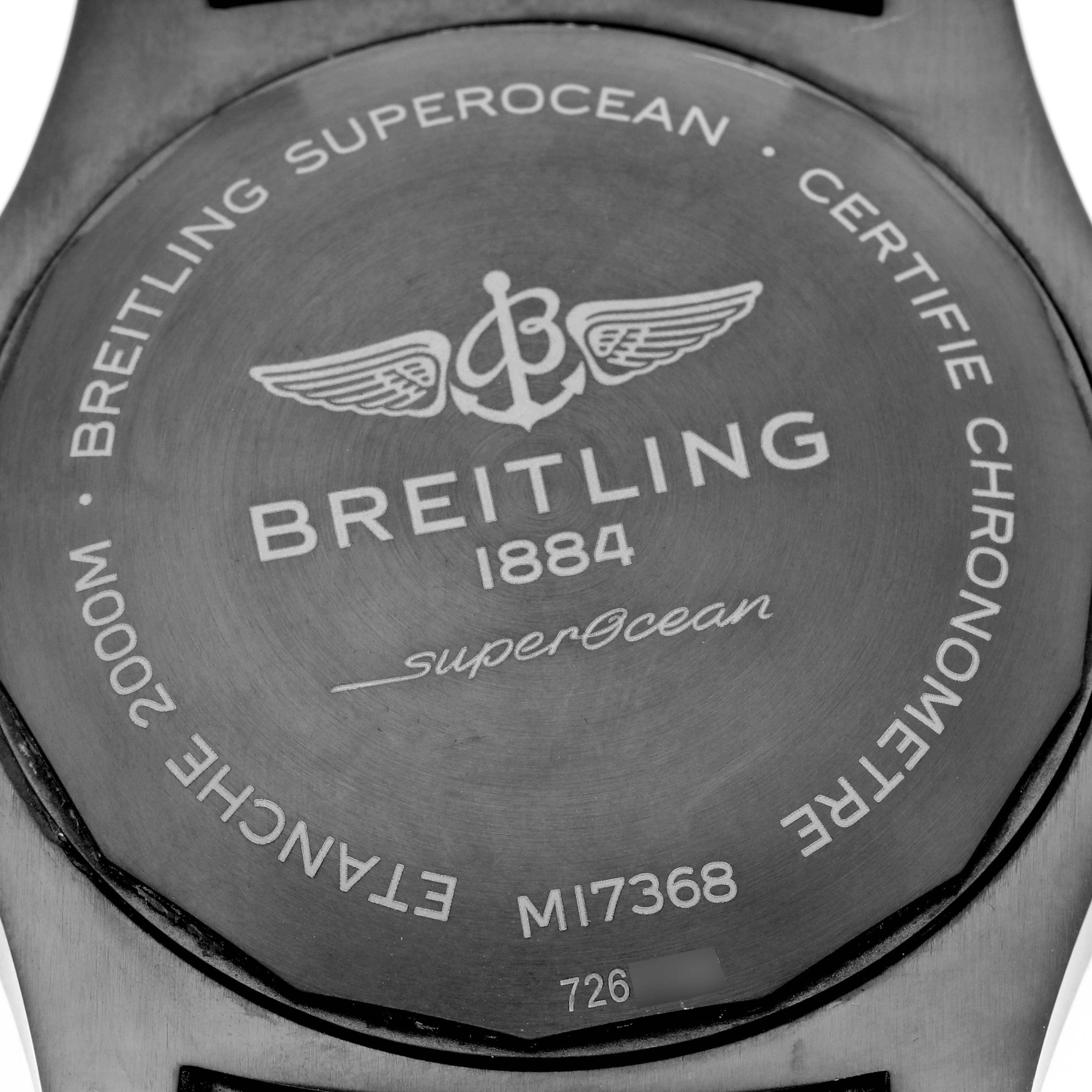 The image shows the back case of a Breitling Superocean M17368 Men's Stainless Steel Blue Dial M17368 Men's Stainless Steel Blue Dial watch, highlighting the branding and engravings.