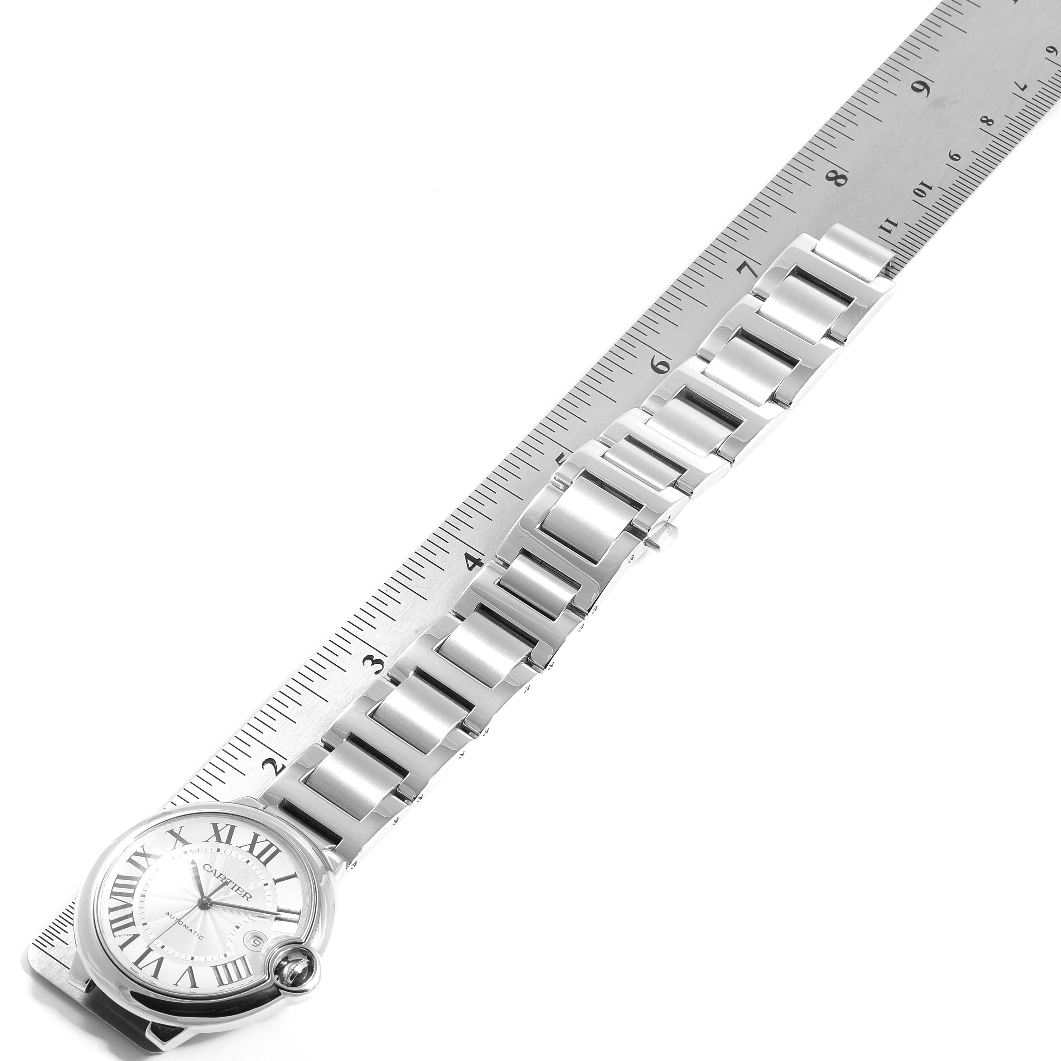 The image shows the entire watch face and metal band of the Cartier Ballon Bleu W69012Z4 Men's Stainless Steel Silver Dial W69012Z4 Men's Stainless Steel Silver Dial model, laid against a ruler.