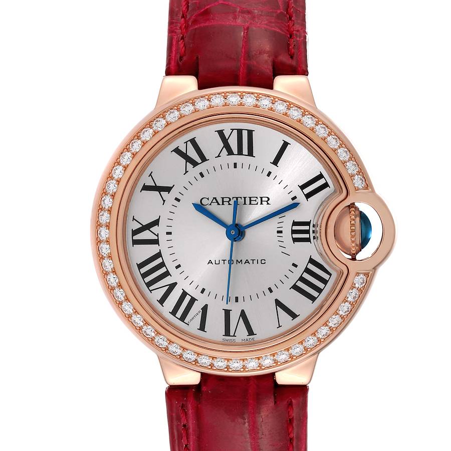 The Cartier Ballon Bleu watch is shown from a front angle, highlighting the dial, Roman numerals, and diamond-encrusted bezel.