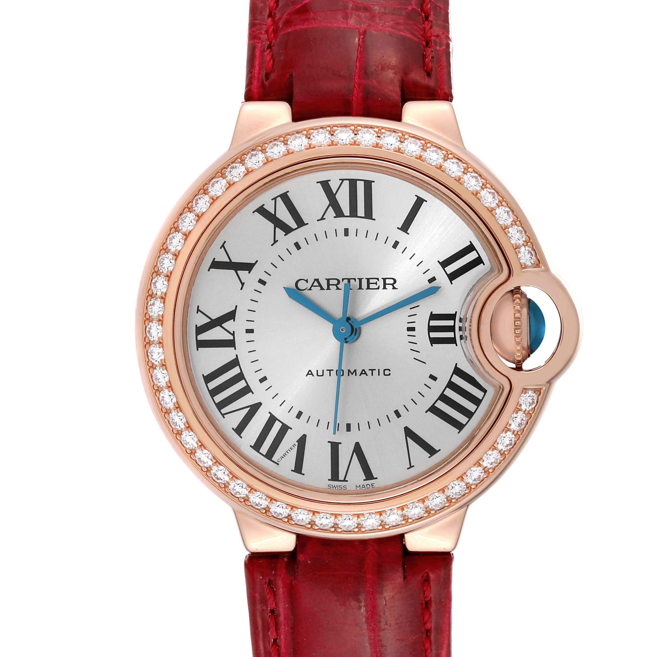 The image shows a front view of the Cartier Ballon Bleu WJBB0033 Women's Rose Gold Silver Dial watch, highlighting the face, bezel with diamonds, crown, and red strap.