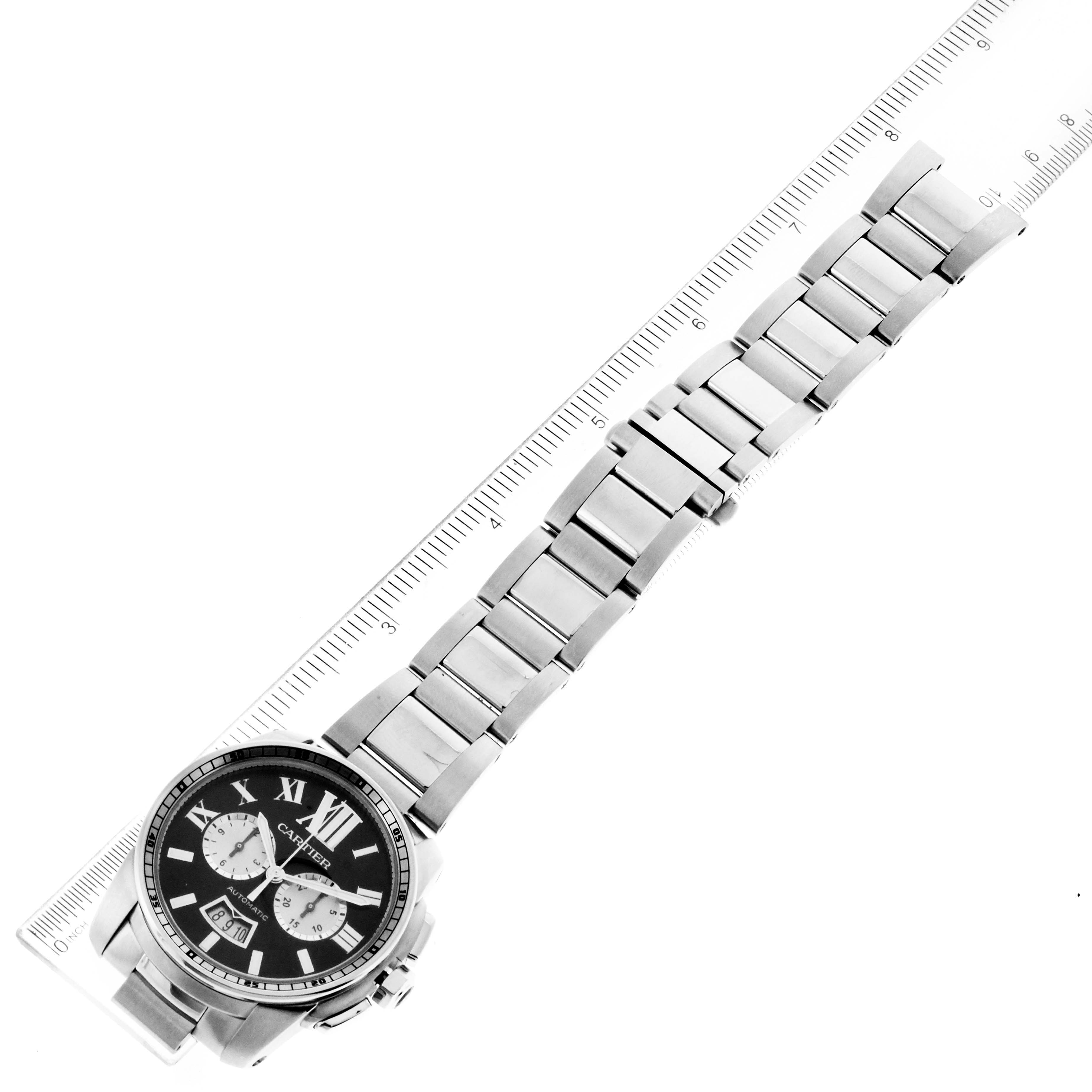 The image shows a top-down view of a Calibre de Cartier watch by Cartier, including its face and metallic bracelet.