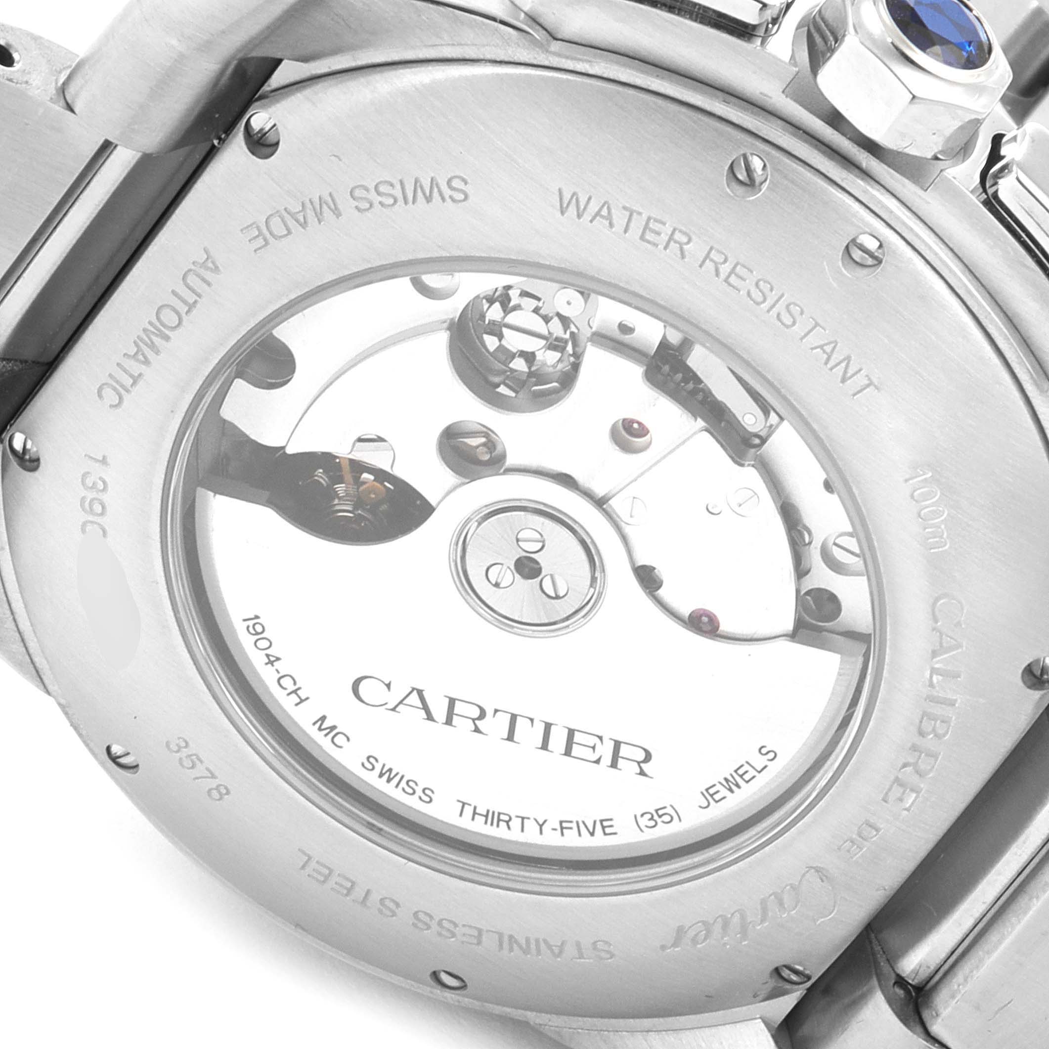 The image shows the back view of a Calibre de Cartier watch by Cartier, highlighting its internal mechanism and inscriptions.