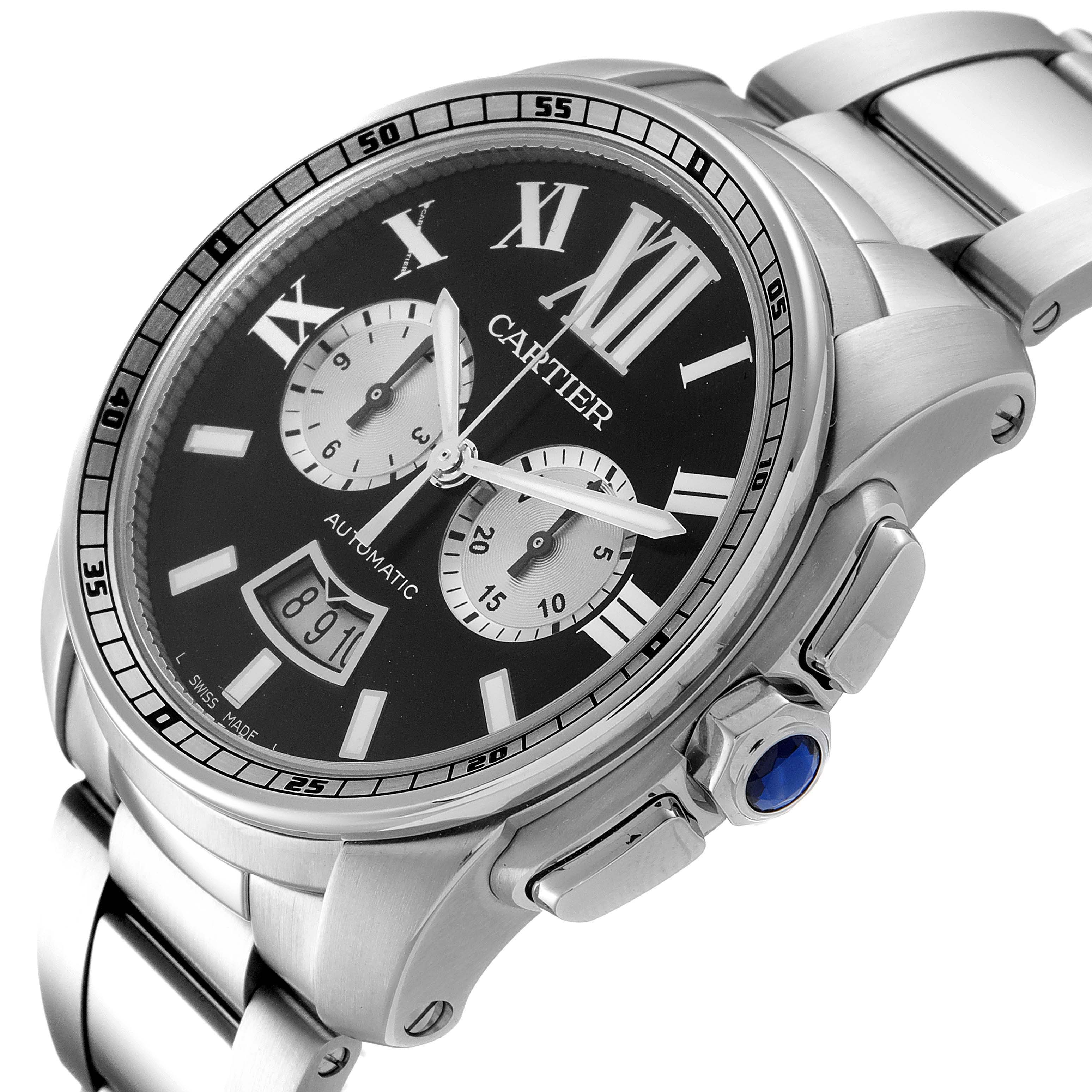 The image shows a Calibre de Cartier model by Cartier from an angled top-down view, highlighting the watch face, crown, and part of the bracelet.