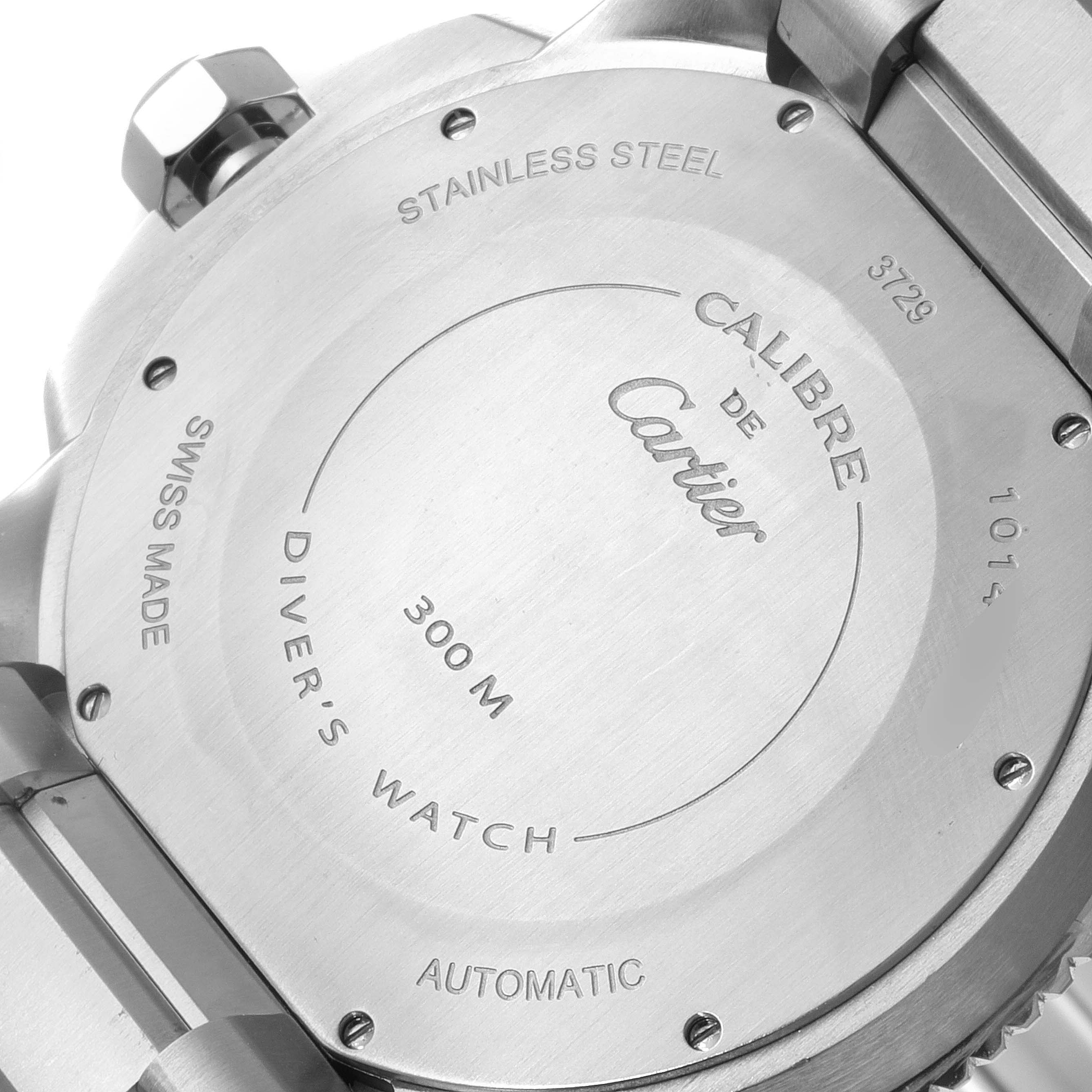 The image shows the stainless steel case back of a Calibre de Cartier watch by Cartier from an angle showing the engraved details.