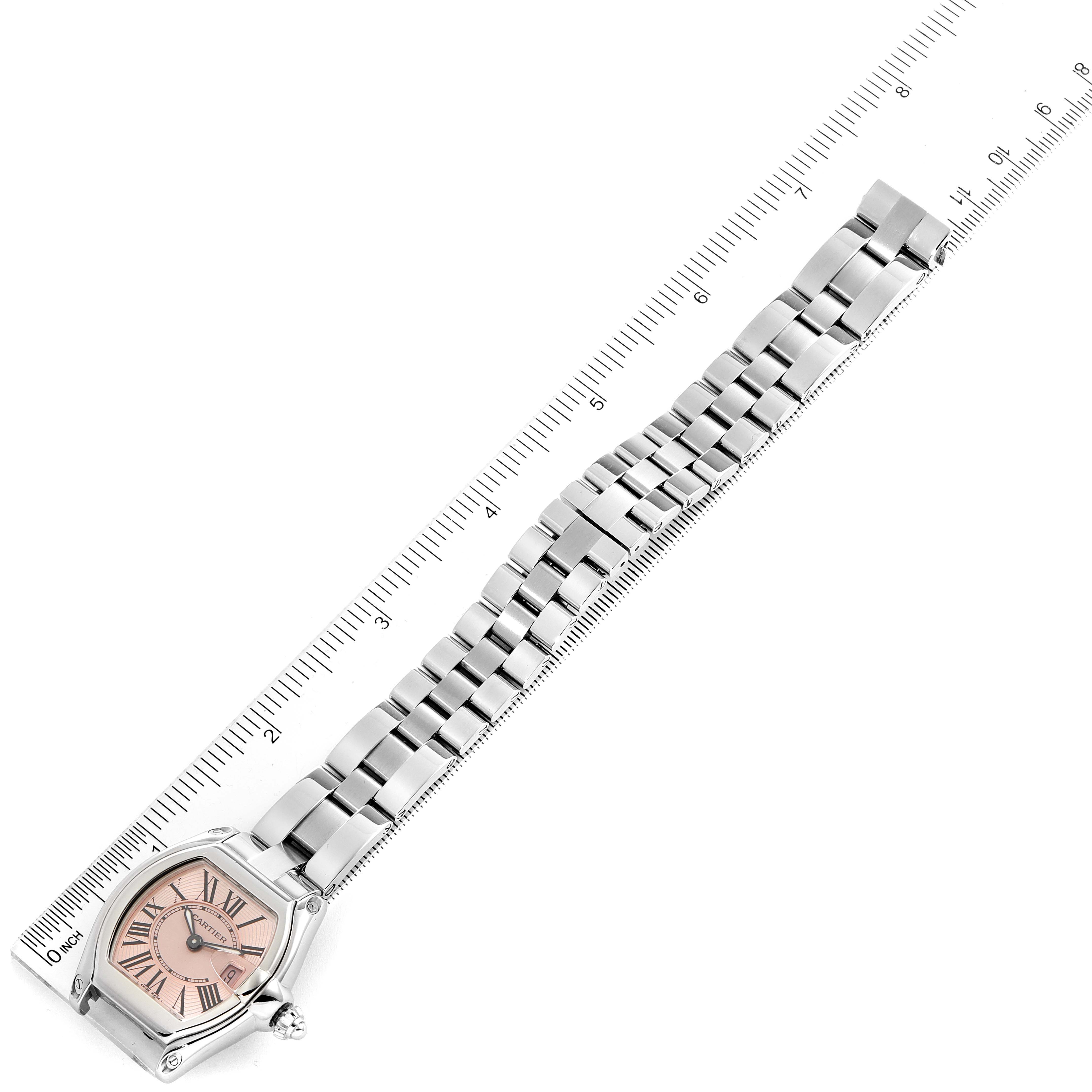 The image shows a Cartier Roadster W62017V3 Women
s Stainless Steel Pink Dial W62017V3 Women
s Stainless Steel Pink Dial watch from an overhead angle, featuring the face and the entire metal bracelet.