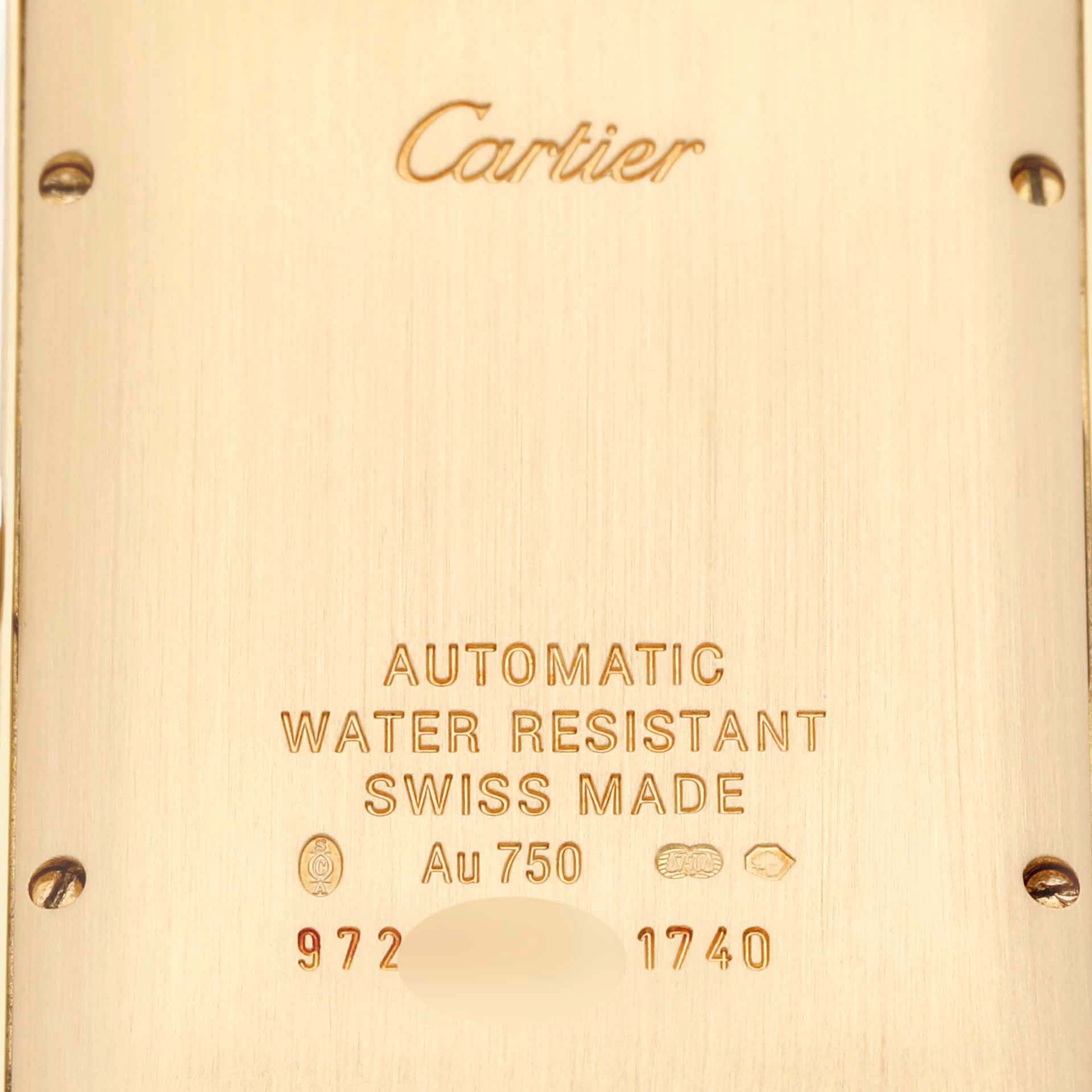 The image shows the back casing of a Cartier Tank Americaine W2603156 Men's Yellow Gold Silver Dial W2603156 Men's Yellow Gold Silver Dial watch, revealing its engravings and screws.