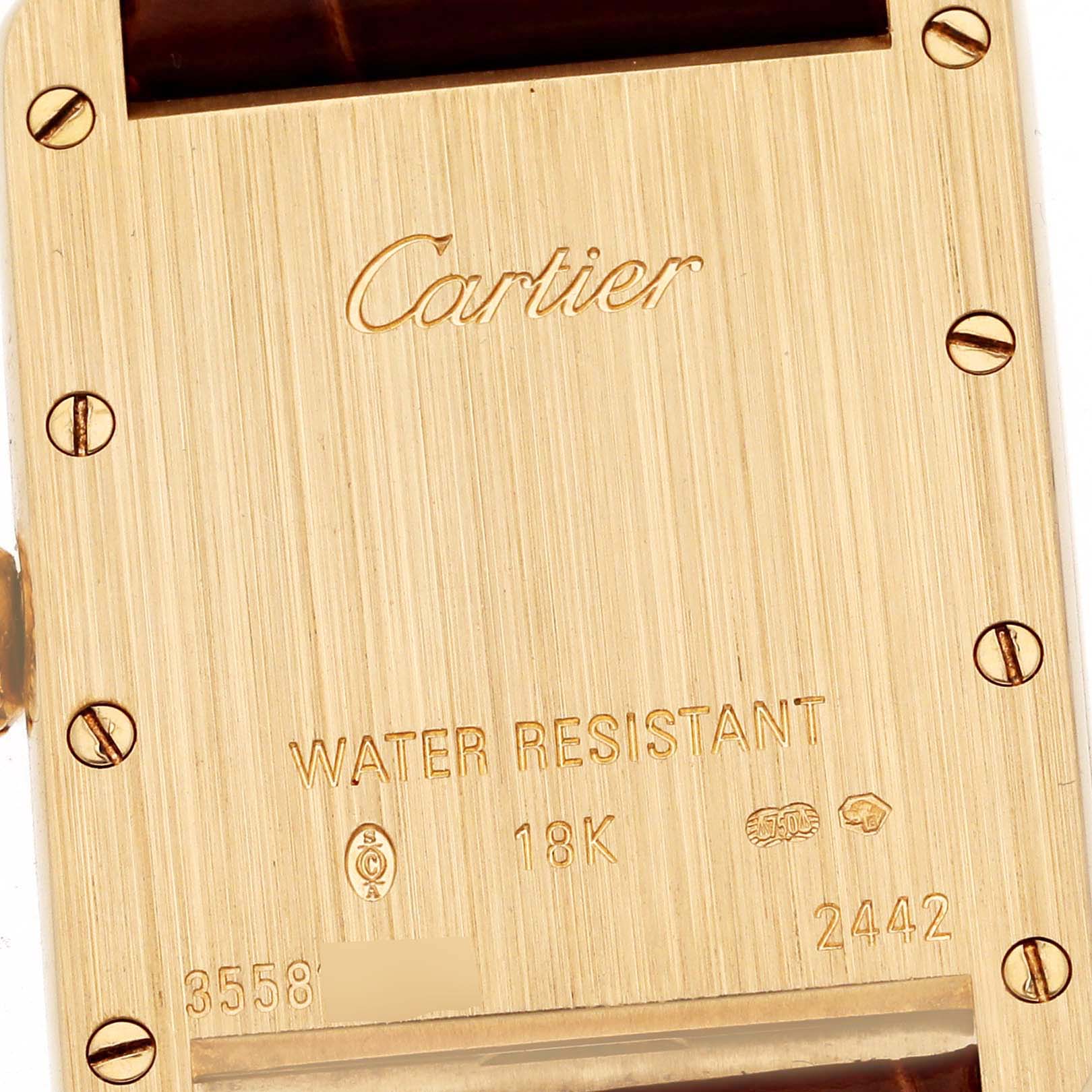 This image shows the back of a Tank Louis watch by Cartier, highlighting the engravings and screws.