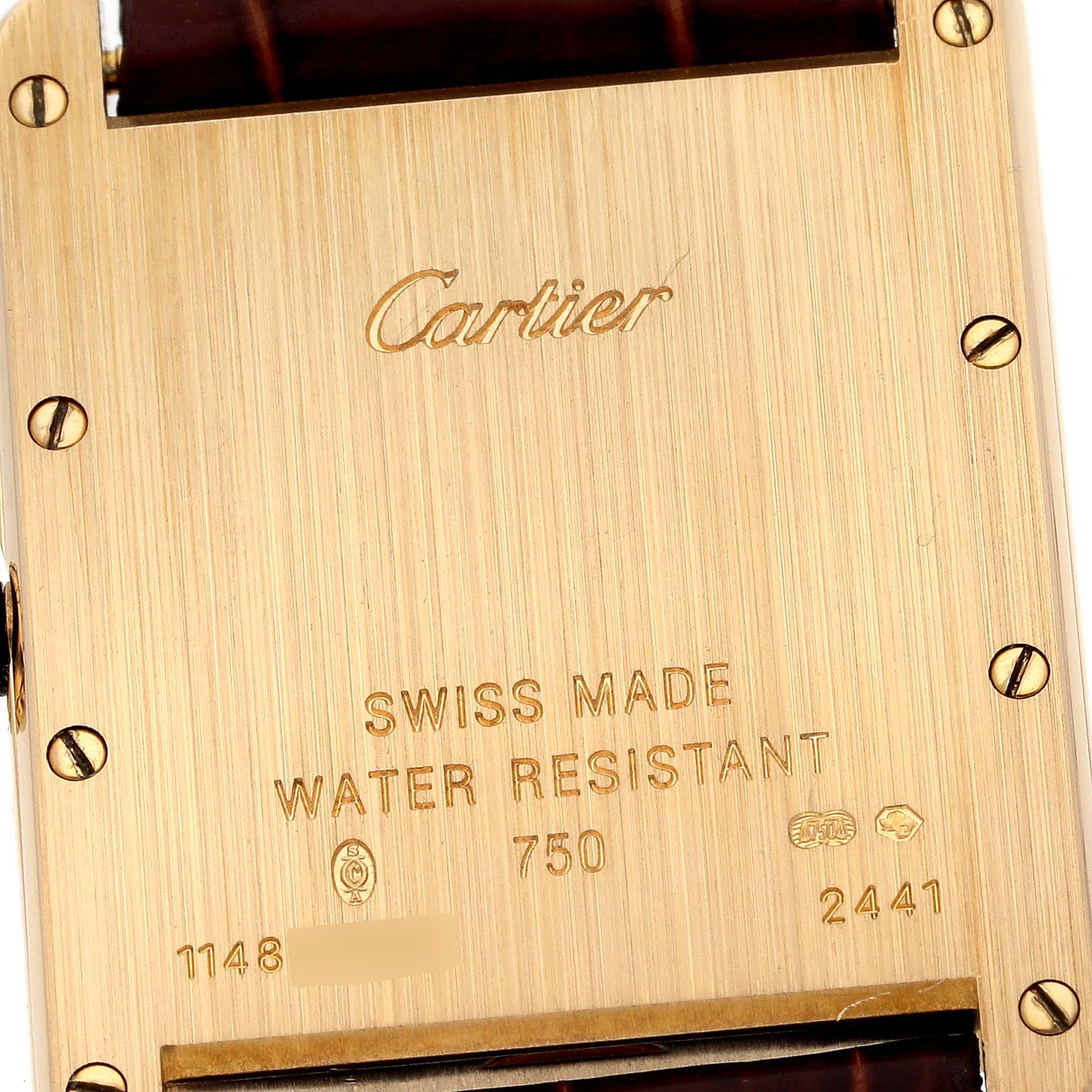 The image shows the engraved back case of a Tank Louis model watch by Cartier, highlighting its material and manufacturing details.
