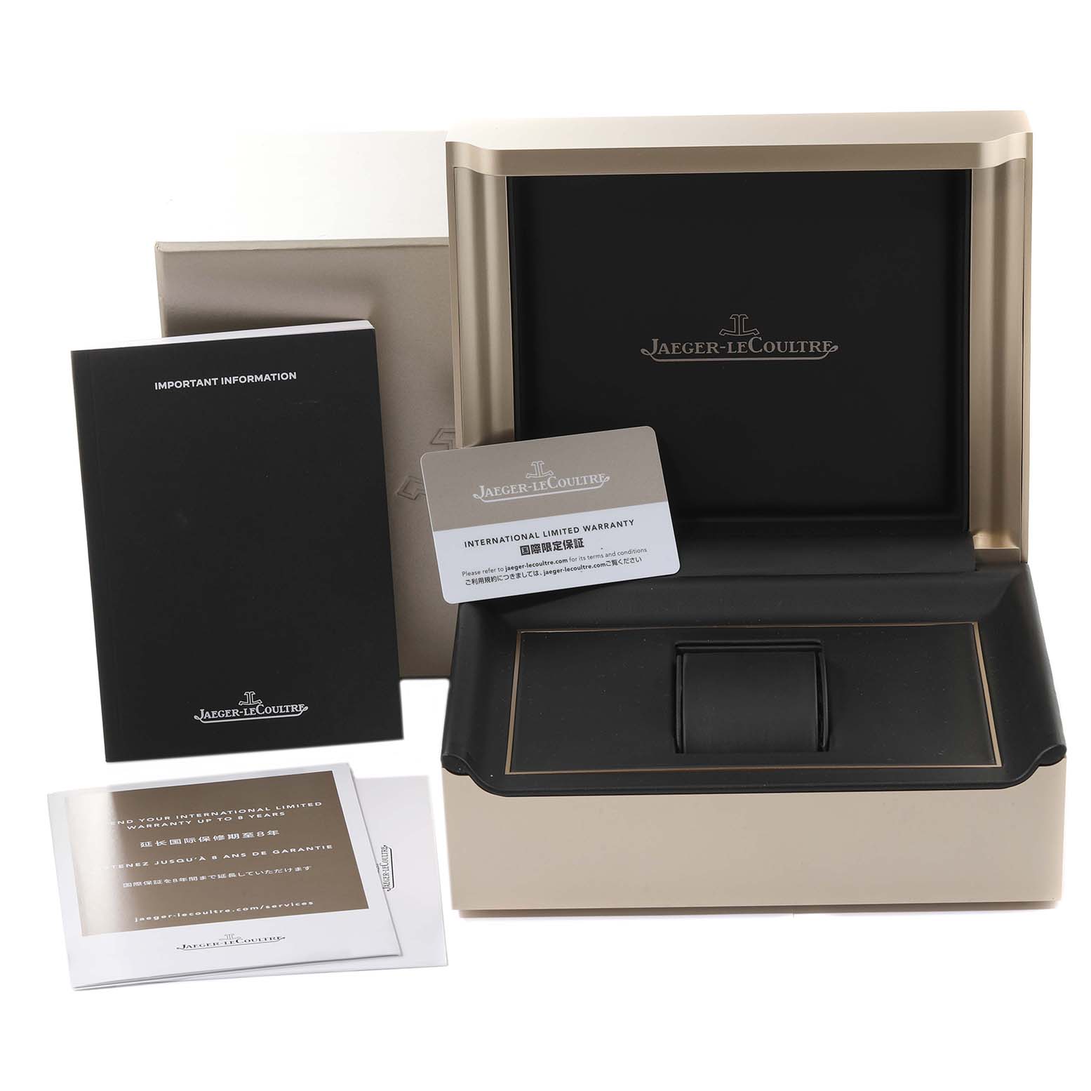 The image shows the box, warranty cards, and information booklets for a Jaeger-LeCoultre Reverso watch.