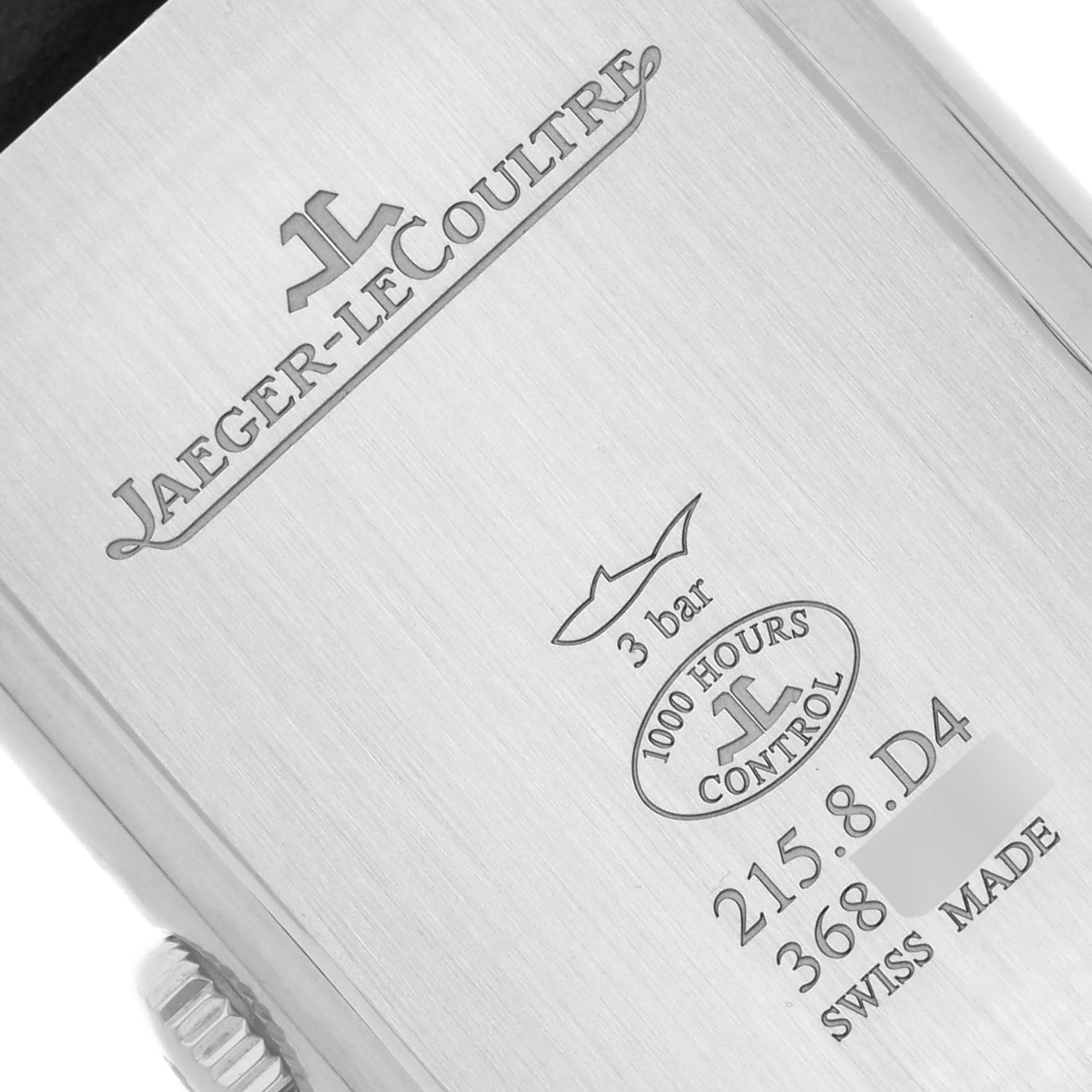 This image shows the back of a Jaeger-LeCoultre Reverso watch displaying engravings of the brand, model number, and specifications.
