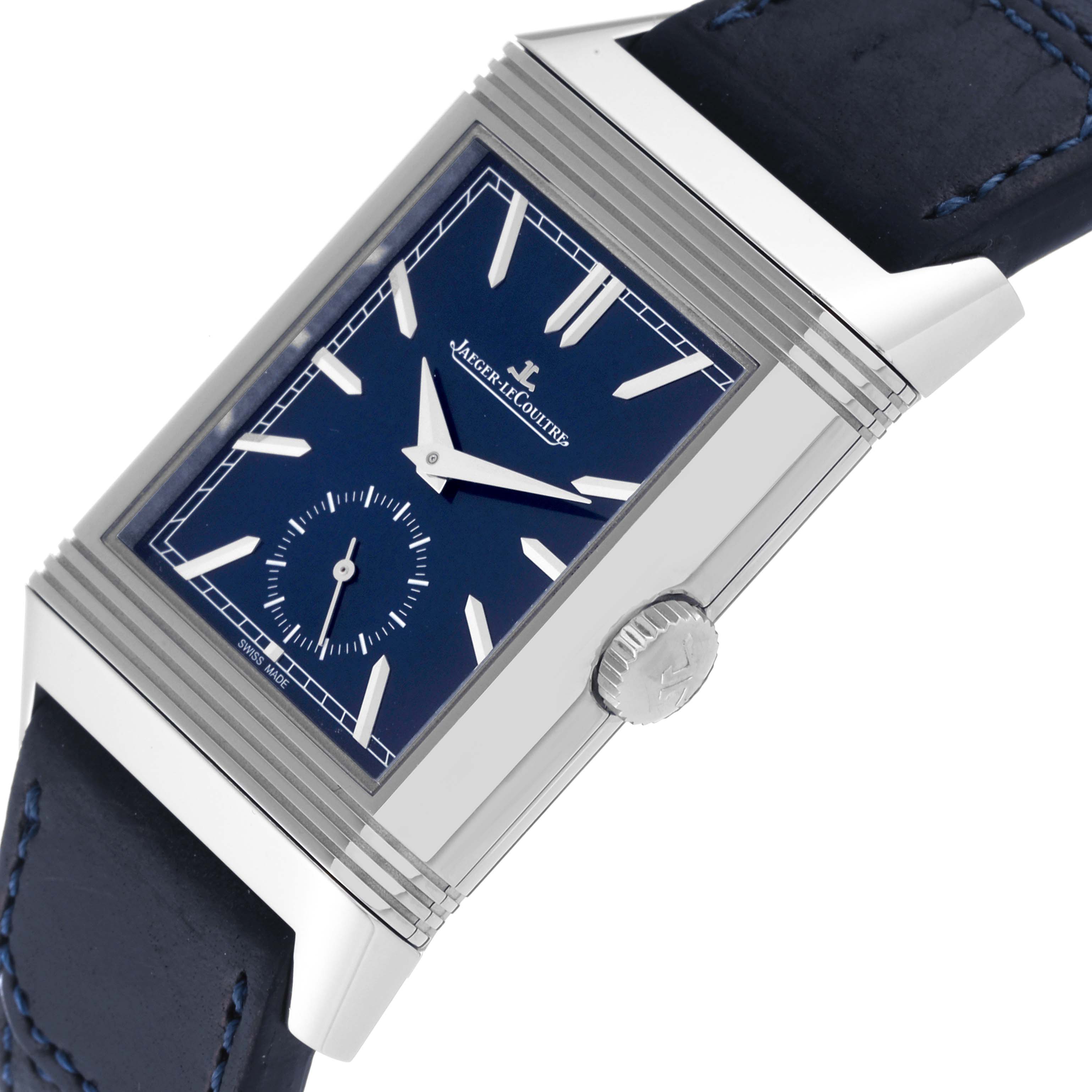 The image shows a close-up of the Jaeger LeCoultre Reverso Q3988482 Men's Stainless Steel Blue Dial Q3988482 Men's Stainless Steel Blue Dial watch, highlighting its blue dial, case, crown, and black strap.