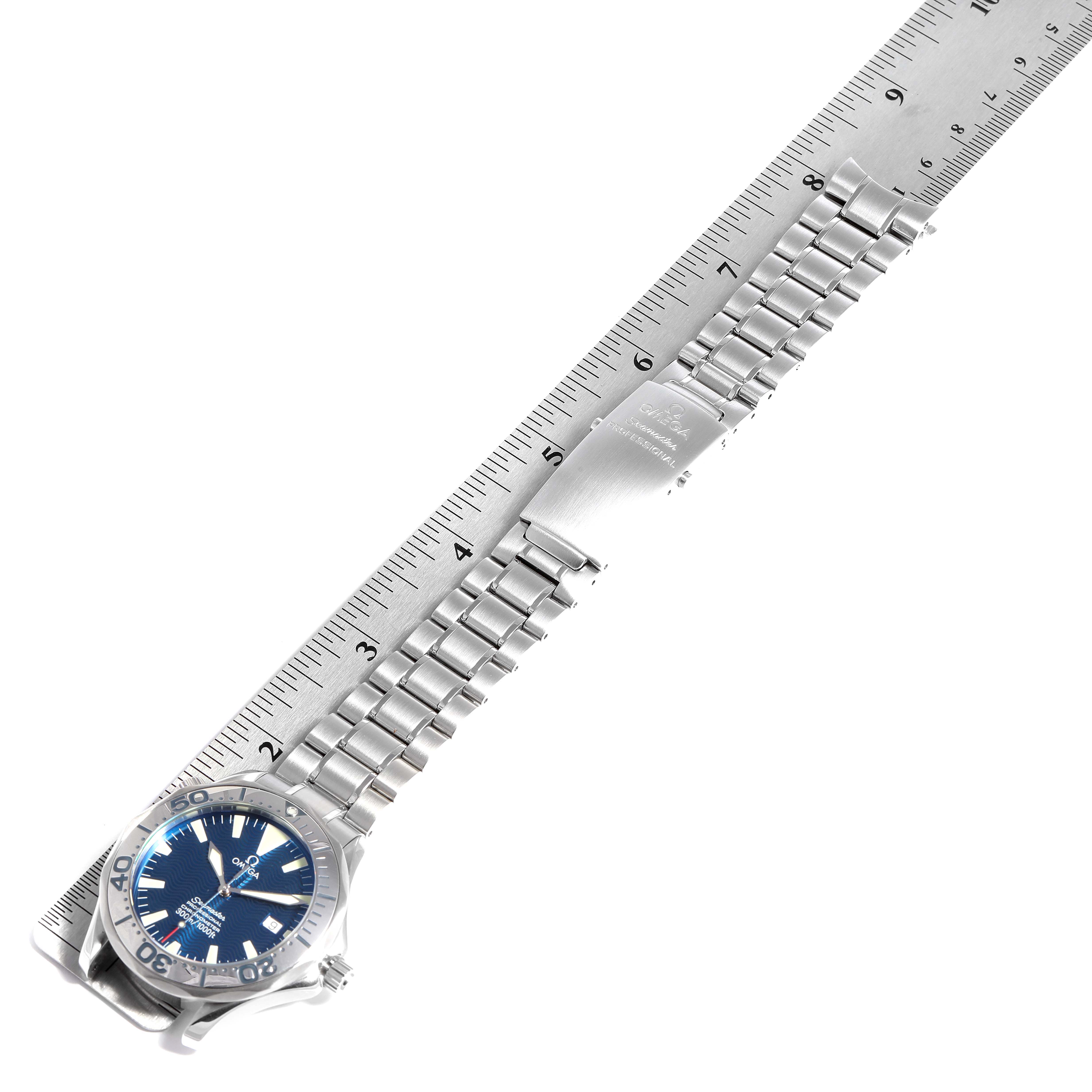 The image shows an Omega Seamaster 2255.80.00 Men
s Stainless Steel Blue Dial 2255.80.00 Men
s Stainless Steel Blue Dial watch laid flat, face up, next to a ruler displaying the length of its metal bracelet.