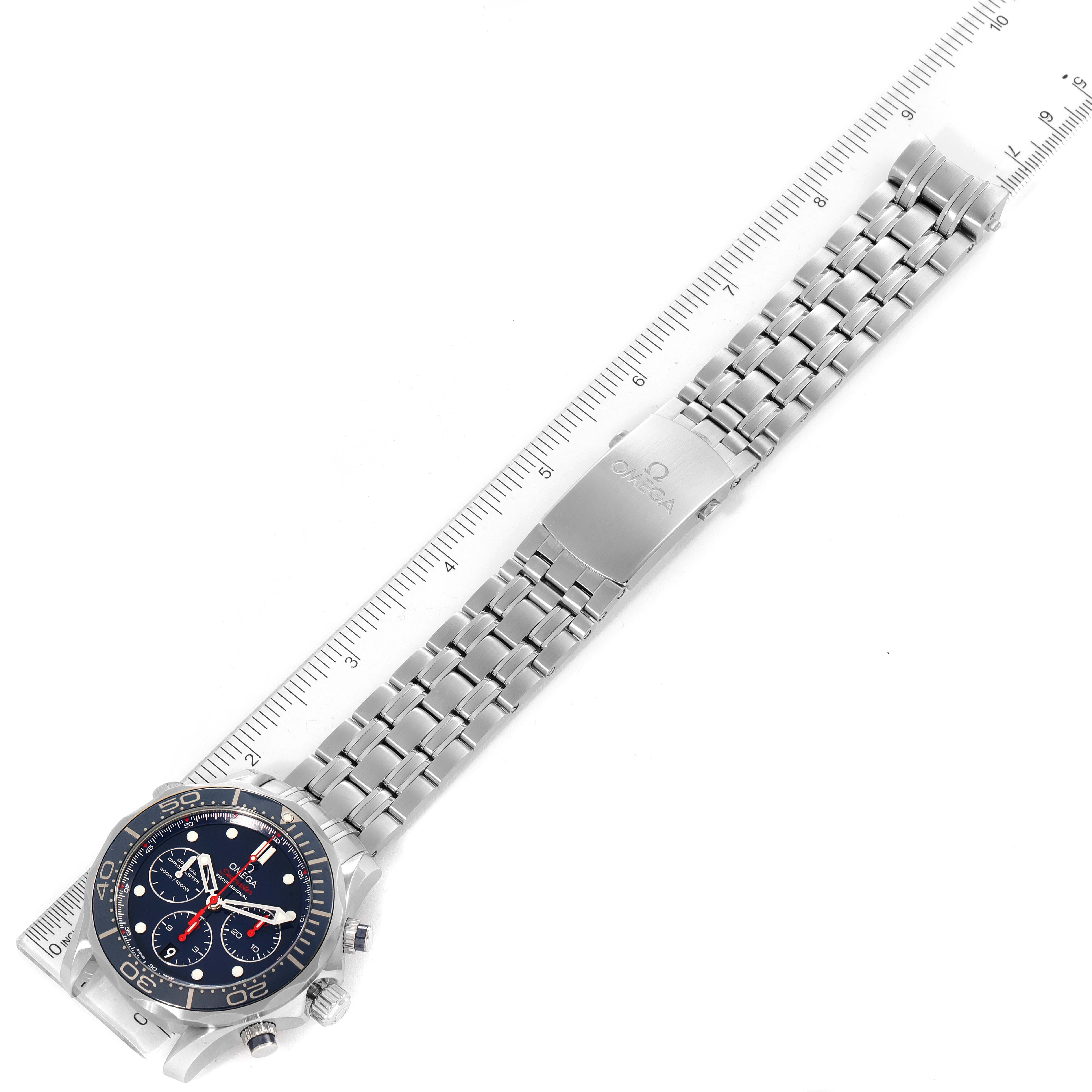 The image shows an Omega Seamaster 212.30.44.50.03.001 Men
s Stainless Steel Blue Dial 212.30.44.50.03.001 Men
s Stainless Steel Blue Dial watch laid flat with its face and stainless steel bracelet displayed against a ruler for measurement.
