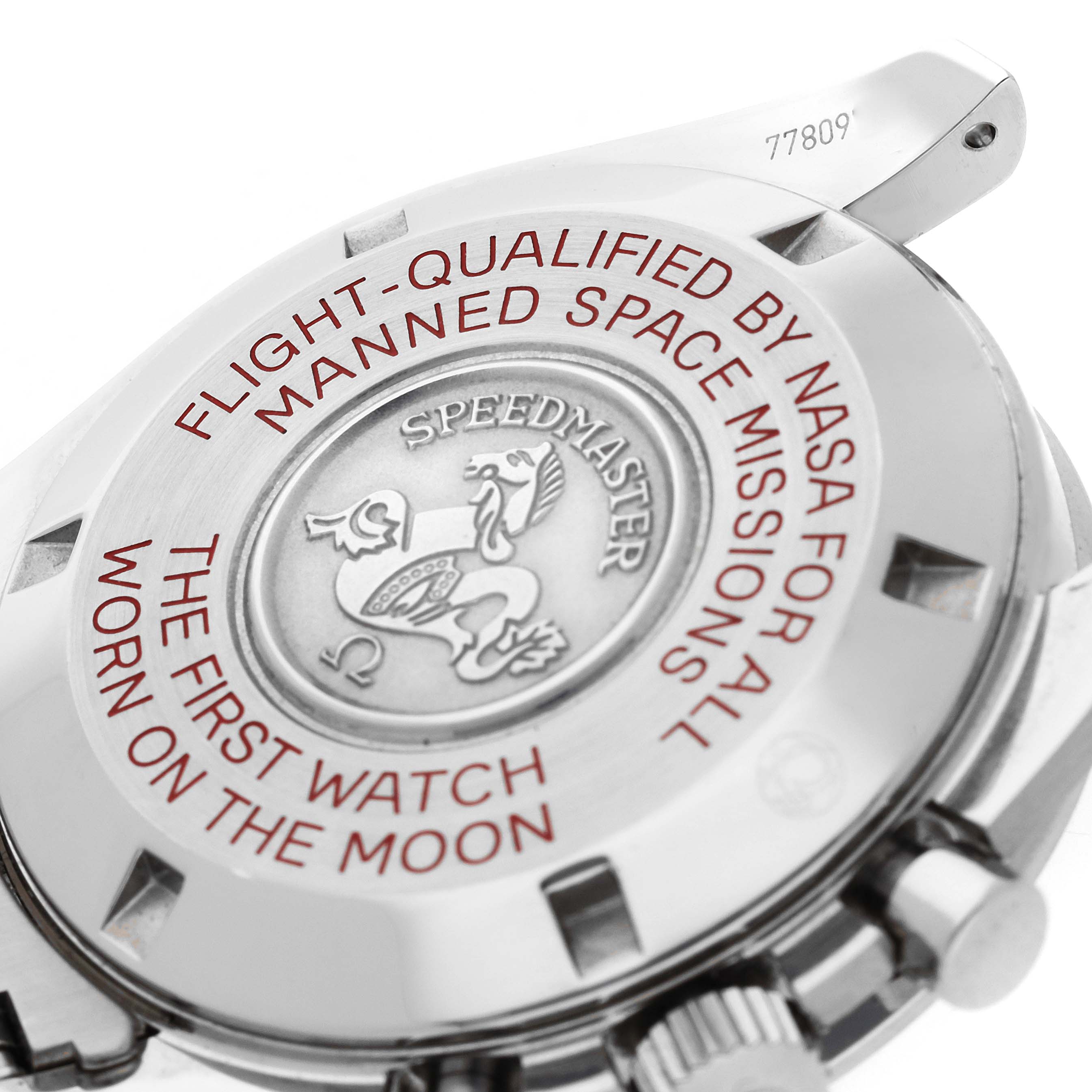 The image shows the case back of an Omega Speedmaster 311.30.42.30.01.004 Men's Stainless Steel Black Dial 311.30.42.30.01.004 Men's Stainless Steel Black Dial, highlighting its engravings and metal texture.