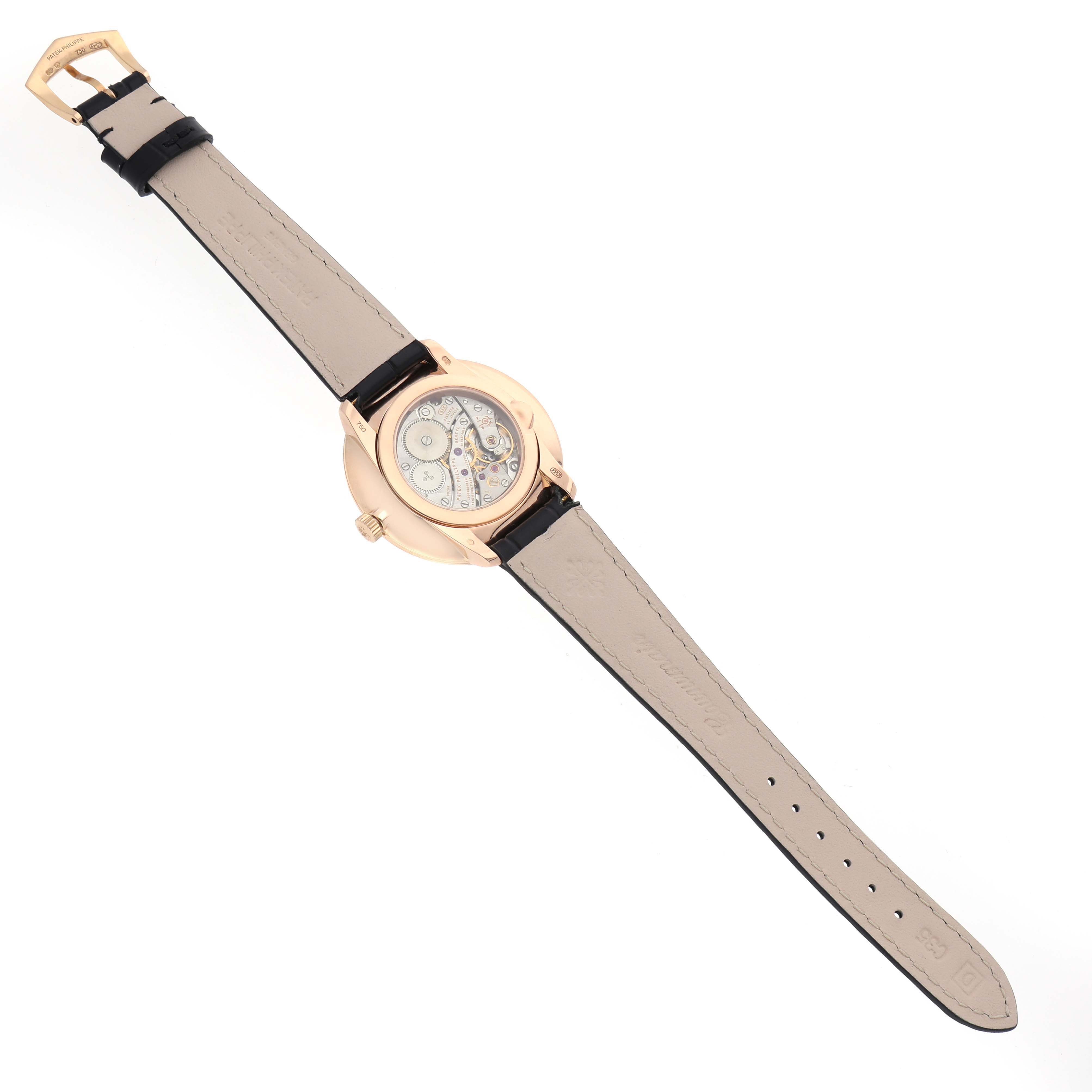 The Patek Philippe Calatrava 5123R-001 Men
s Rose Gold Silver Dial 5123R-001 Men
s Rose Gold Silver Dial watch is shown from the back, displaying its movement and leather strap.