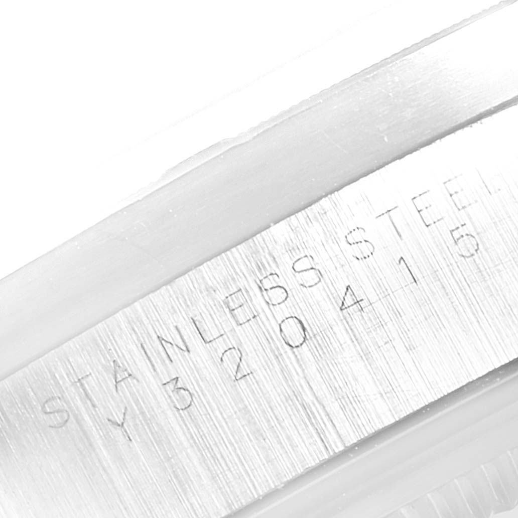This image shows a close-up angle of the serial number and "STAINLESS STEEL" engraving on the side of the case of a Rolex Air-King 14010 Men's Stainless Steel Silver Dial 14010 Men's Stainless Steel Silver Dial watch.