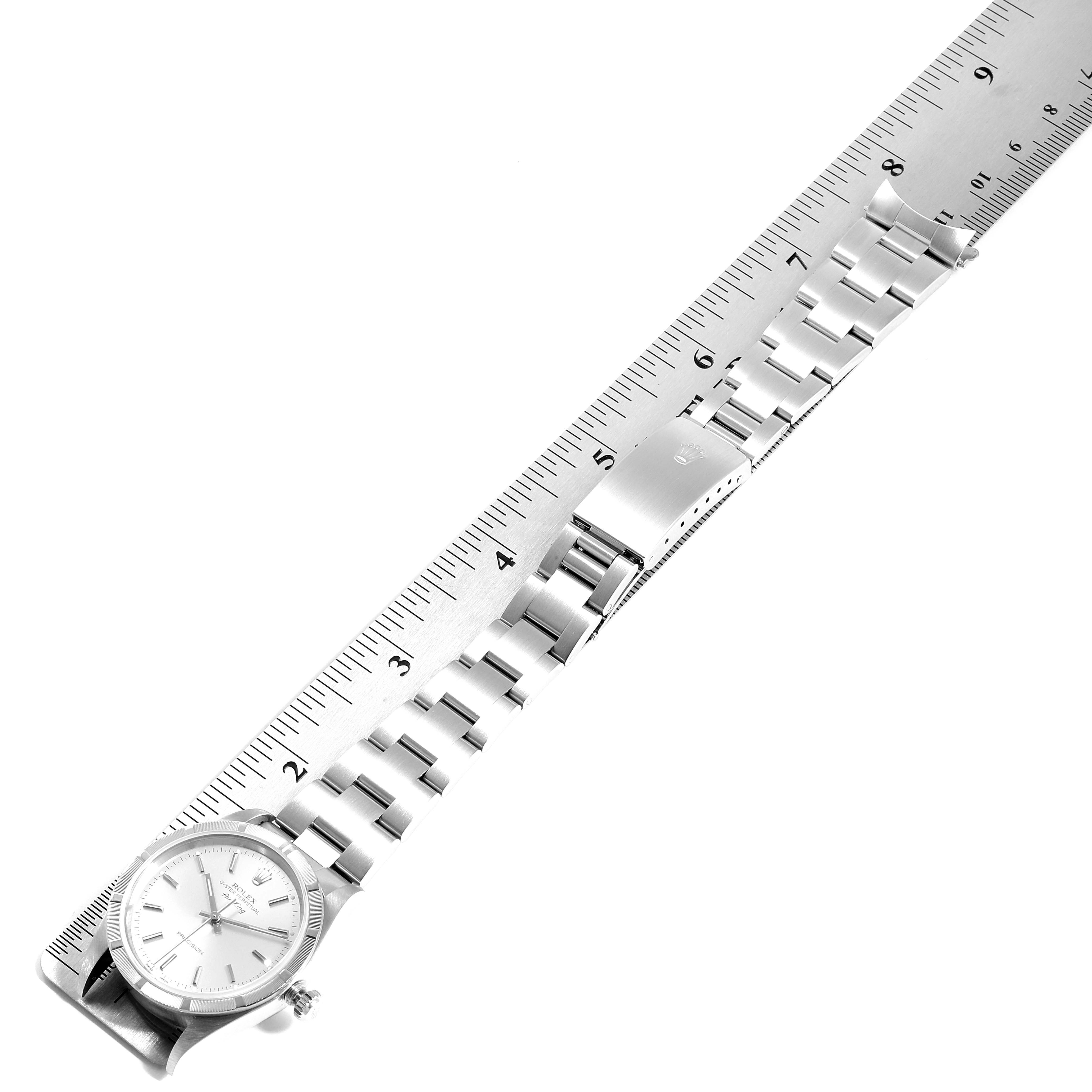 This image shows the Rolex Air-King 14010 Men's Stainless Steel Silver Dial 14010 Men's Stainless Steel Silver Dial watch laid flat, with its bracelet extended and measured against a ruler.
