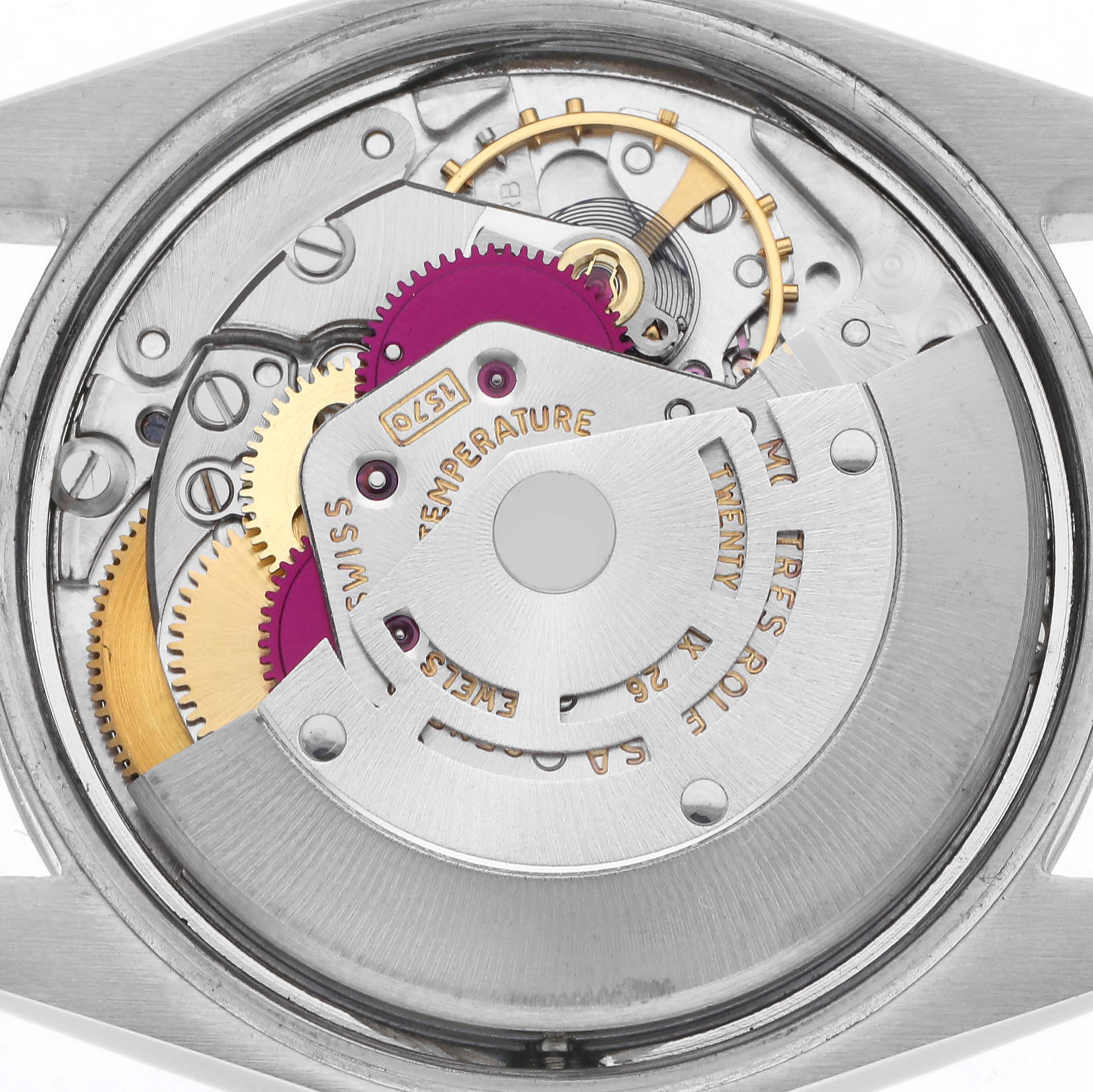 The image shows the Rolex Date model's movement from the back, highlighting gears and intricate mechanical parts.