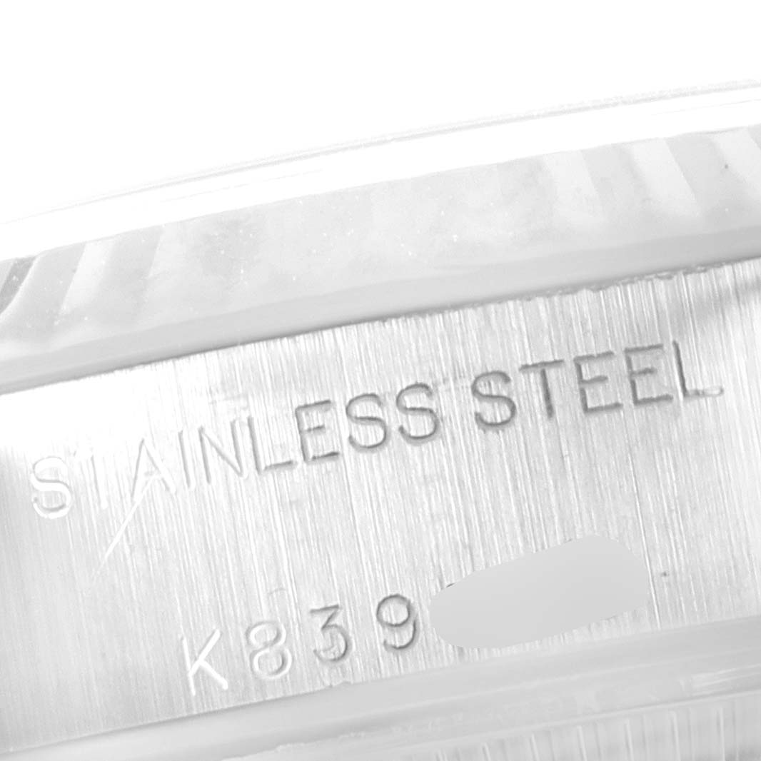This image displays a close-up of the engraved text on the side of the stainless steel case of the Rolex Datejust 79174 Women
s Stainless Steel Blue Dial 79174 Women
s Stainless Steel Blue Dial watch.