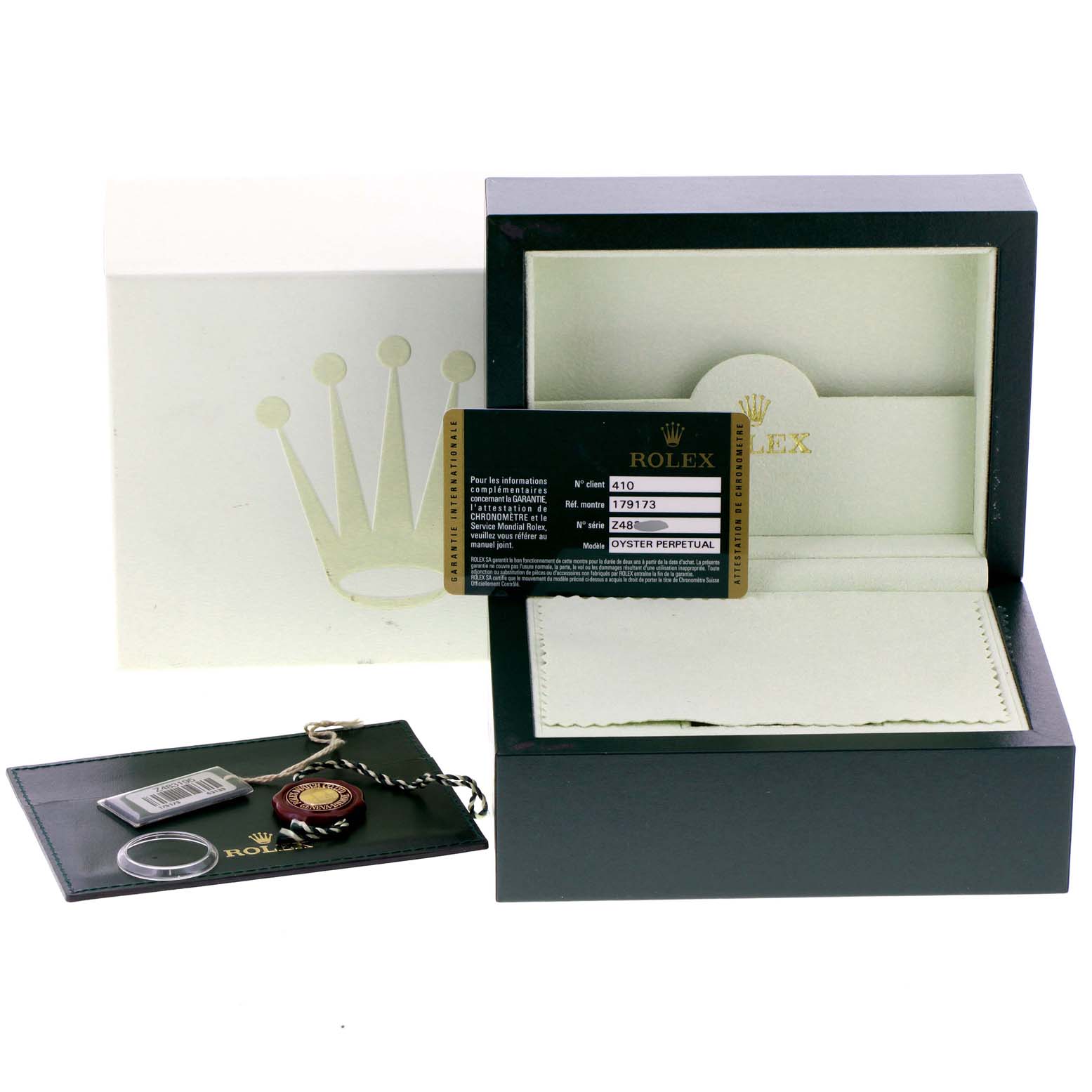The image shows the packaging and accessories of a Rolex Datejust 179173 Women
s Steel and Gold (two tone) White Dial 179173 Women
s Steel and Gold (two tone) White Dial, including the box, guarantee card, and tags.