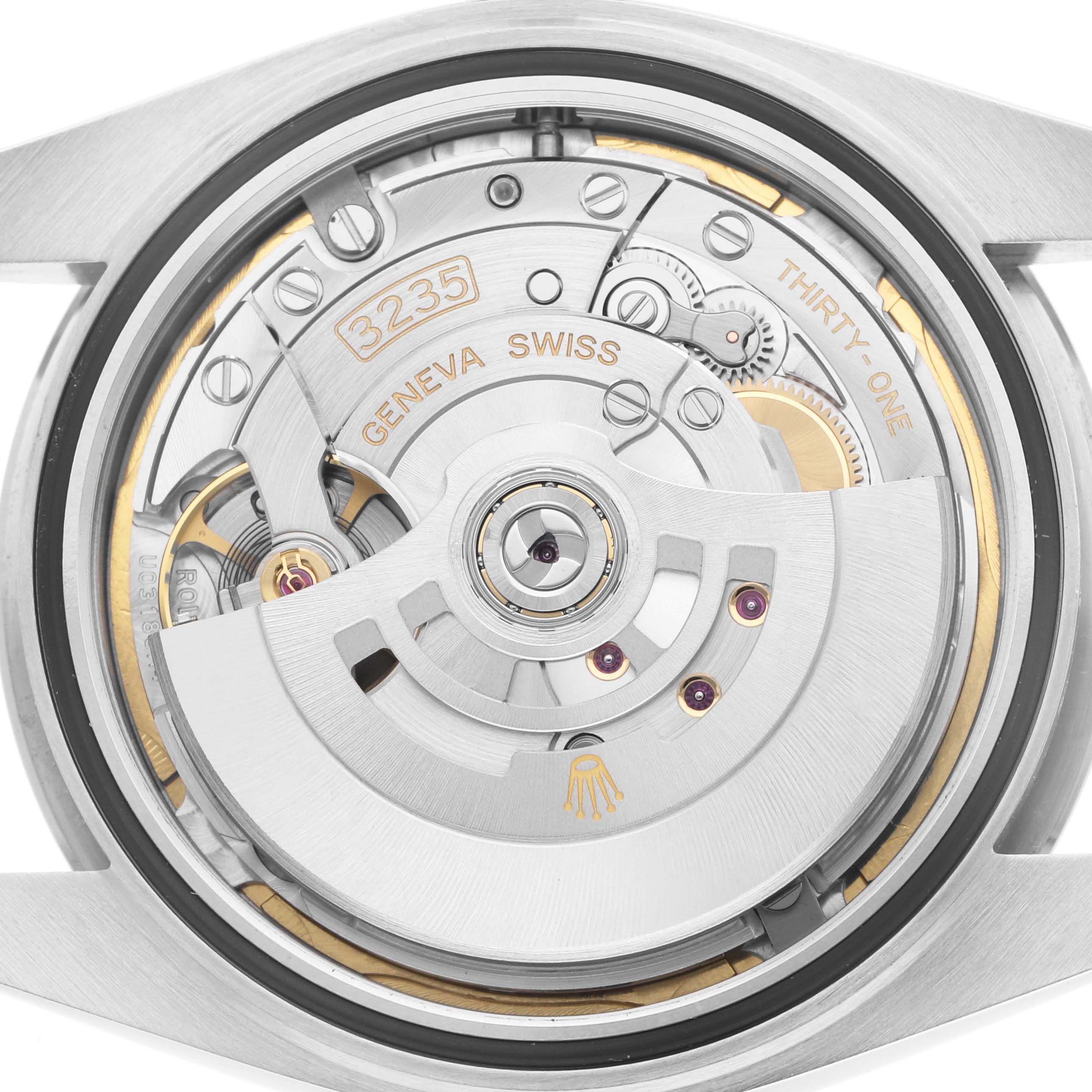 The image shows the movement of a Rolex Datejust 41 126334 Men's Stainless Steel Blue Dial 126334 Men's Stainless Steel Blue Dial, featuring its intricate gears and rotor, viewed from the back.