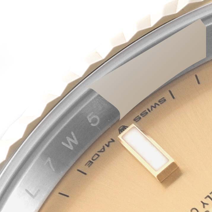 This close-up shows part of the bezel and dial of the Rolex Datejust 41 126333 Men's Steel and Gold (two tone) Champagne Dial 126333 Men's Steel and Gold (two tone) Champagne Dial watch, highlighting the Swiss Made text.