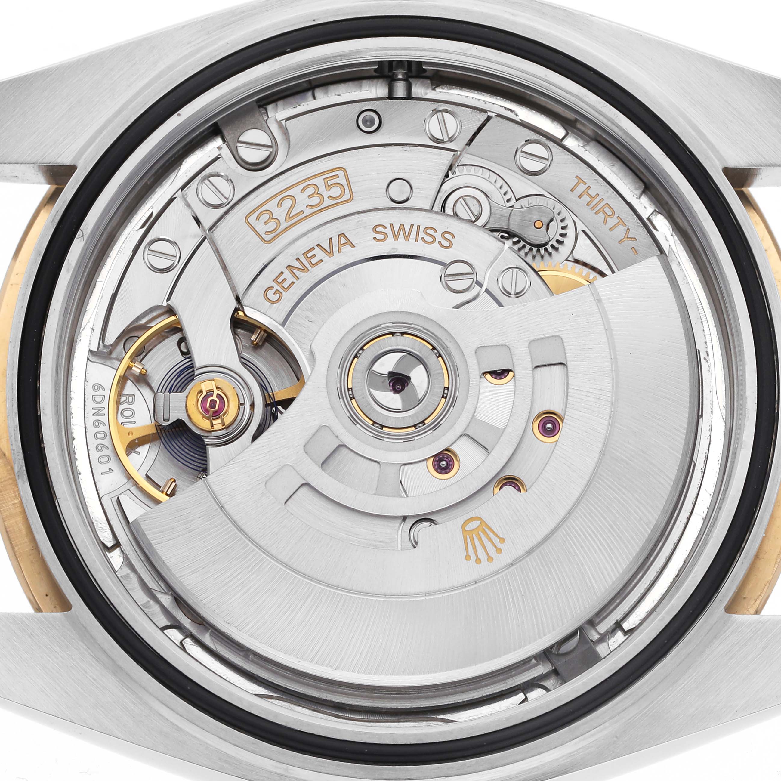 The image shows the movement of a Rolex Datejust 41 126333 Men's Steel and Gold (two tone) Silver Dial 126333 Men's Steel and Gold (two tone) Silver Dial, focusing on the intricate mechanical components and rotor.