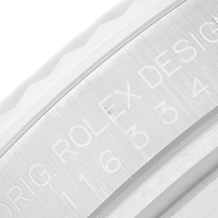 The image shows a close-up of the bezel with engraving on the Rolex Datejust 41 116334 Men's Stainless Steel Blue Dial 116334 Men's Stainless Steel Blue Dial model.