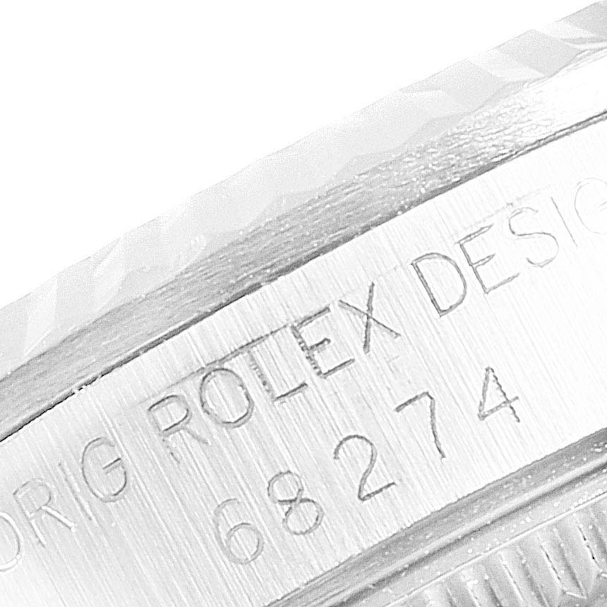 The image shows a close-up of the engraved bezel and case side of a Mid-Size Rolex watch.