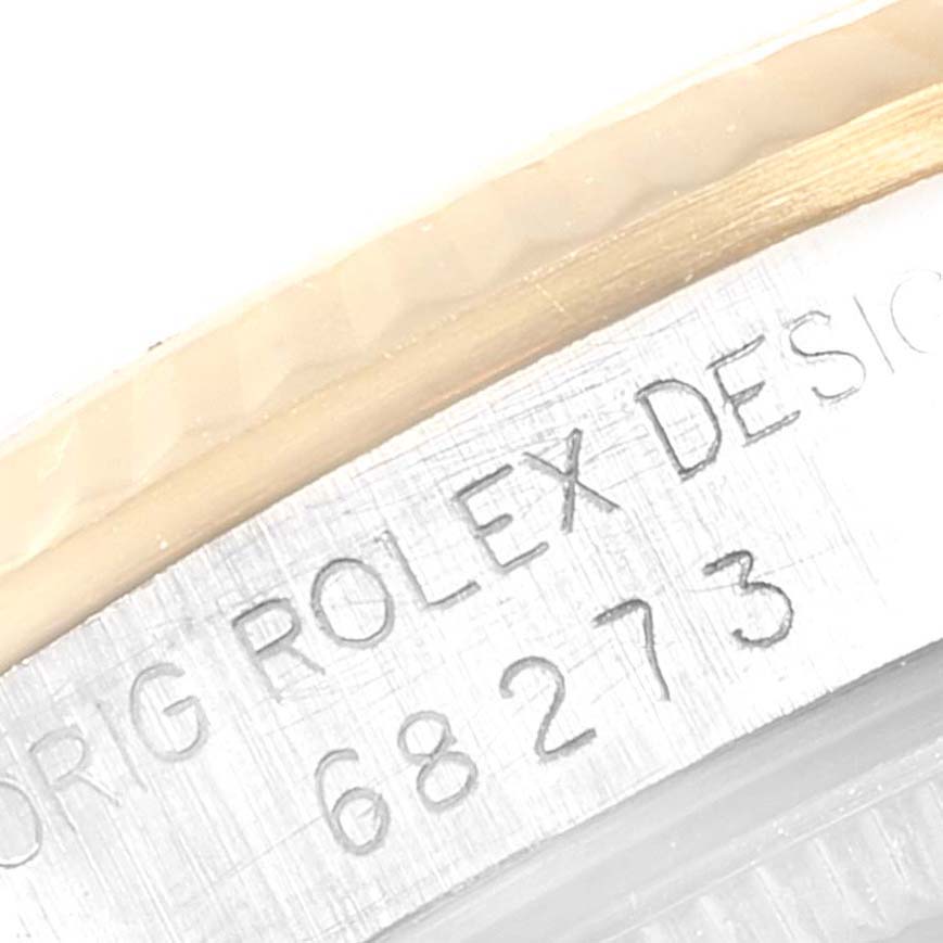 The image shows a close-up of the case back engraving on a Rolex Mid-Size 68273 Women
s Steel and Gold (two tone) Silver Dial 68273 Women
s Steel and Gold (two tone) Silver Dial model, highlighting the model number and "Rolex Design" text.