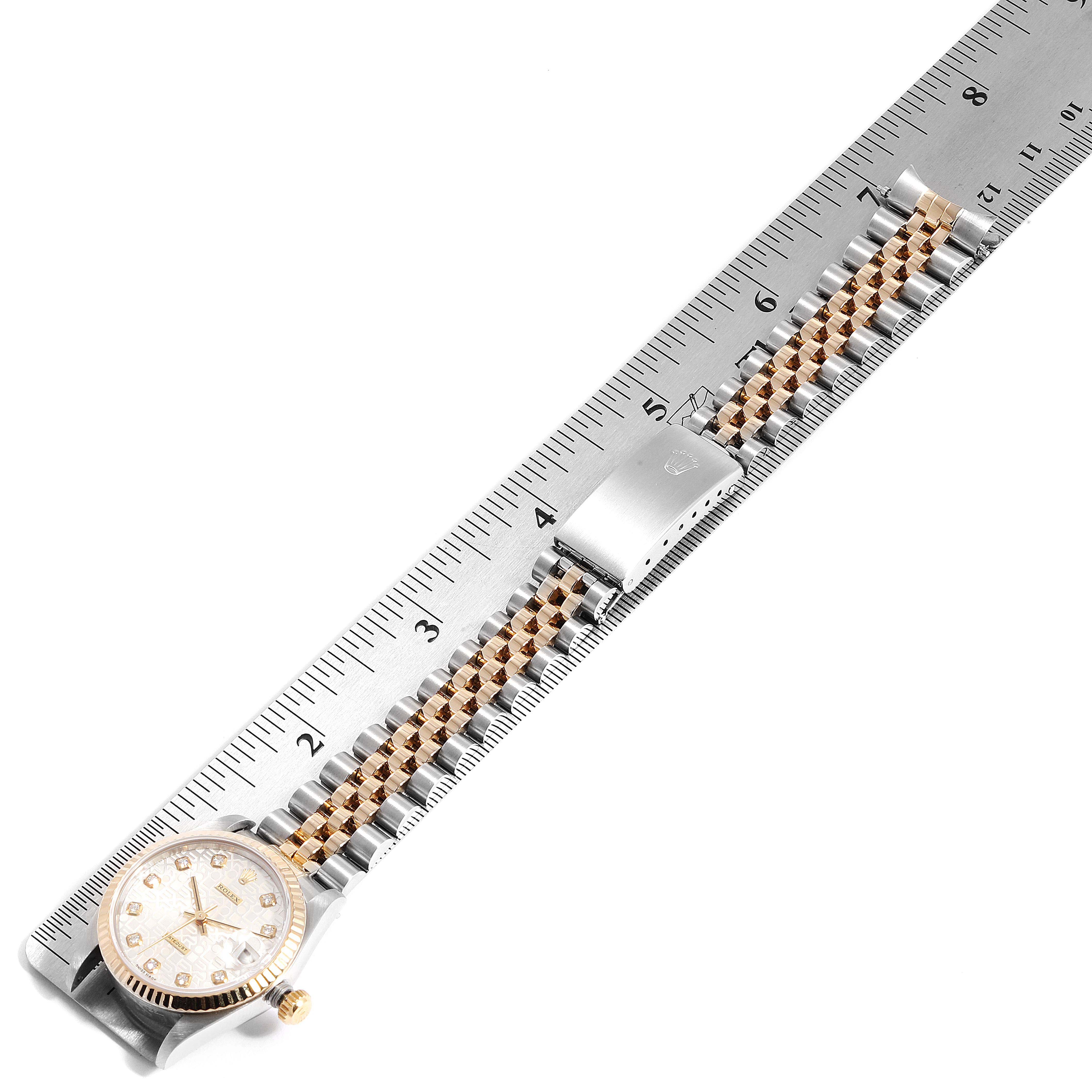 The image shows a Rolex Mid-Size 68273 Women
s Steel and Gold (two tone) Silver Dial 68273 Women
s Steel and Gold (two tone) Silver Dial model watch, laid flat against a ruler, displaying its full face, bracelet, and clasp.