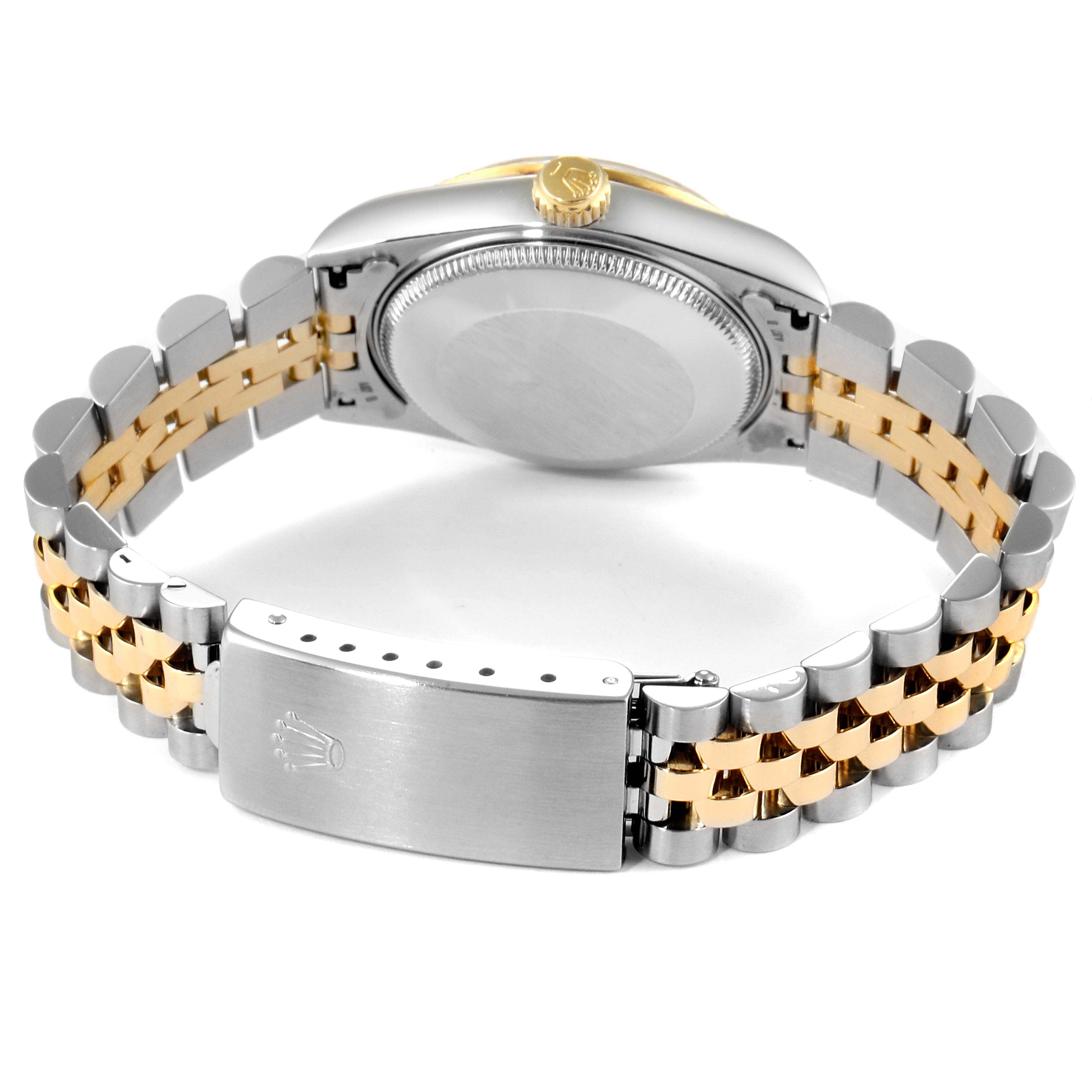 The image shows the case back, crown, and two-tone bracelet of a Rolex Mid-Size 68273 Women
s Steel and Gold (two tone) Silver Dial 68273 Women
s Steel and Gold (two tone) Silver Dial model watch from a rear angle.