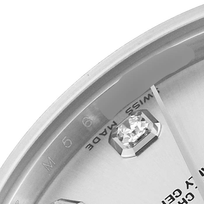 The image shows a close-up of the dial and part of the bezel of a Mid-Size Rolex watch, highlighting a diamond hour marker and "Swiss Made" text.