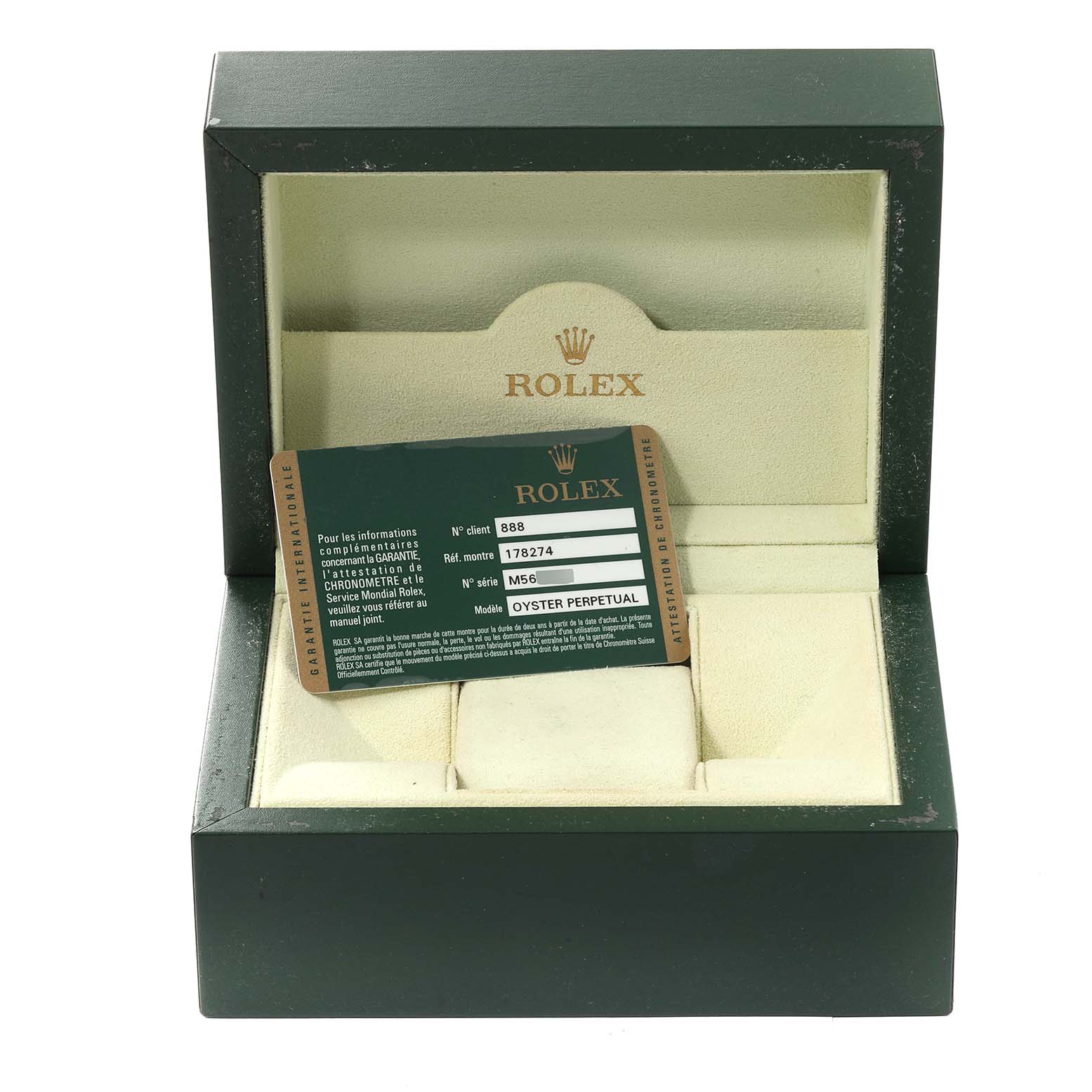 This image shows an open Rolex watch box at an angled view, containing a warranty card for the Mid-Size model.