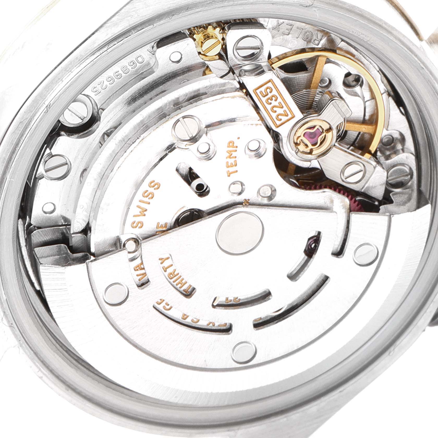This is an interior view of the Rolex Datejust 79163 Women's Steel and Gold (two tone) Silver Dial 79163 Women's Steel and Gold (two tone) Silver Dial watch, showing its intricate movement and mechanical parts.