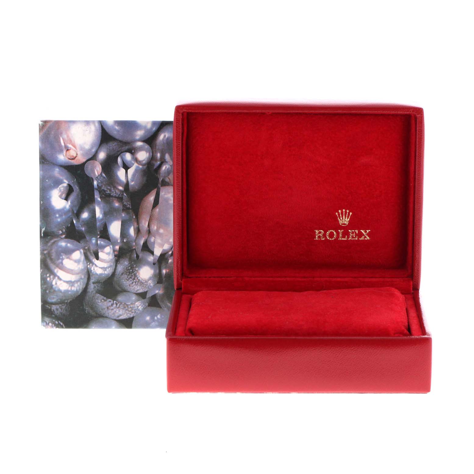 The image shows an open red Rolex box for a Datejust model, with a cushion inside and a decorative background.