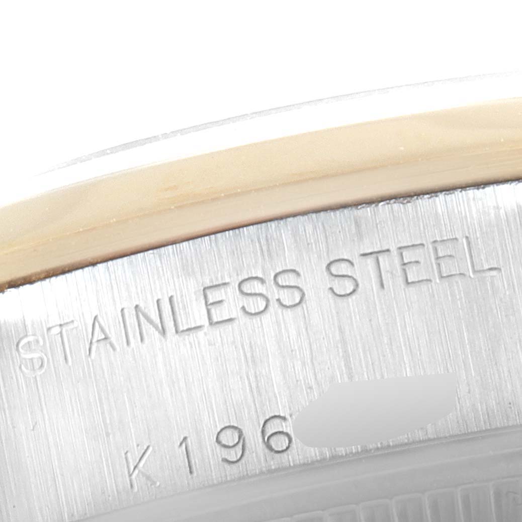 This close-up image shows the writing on the stainless steel case back of a Rolex Datejust 79163 Women's Steel and Gold (two tone) Silver Dial 79163 Women's Steel and Gold (two tone) Silver Dial model watch.