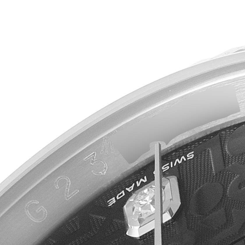 This close-up image shows part of the dial and bezel of a Rolex Datejust 116234 Men's Stainless Steel Black Dial 116234 Men's Stainless Steel Black Dial watch.