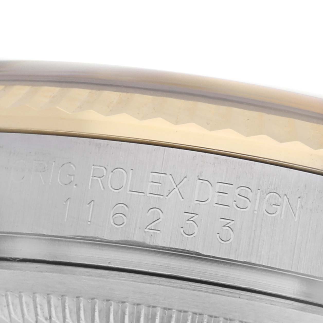 The image shows a close-up of the engraved case side on a Rolex Datejust 116233 Men's Steel and Gold (two tone) Champagne Dial 116233 Men's Steel and Gold (two tone) Champagne Dial, highlighting the serial number and bezel edge.