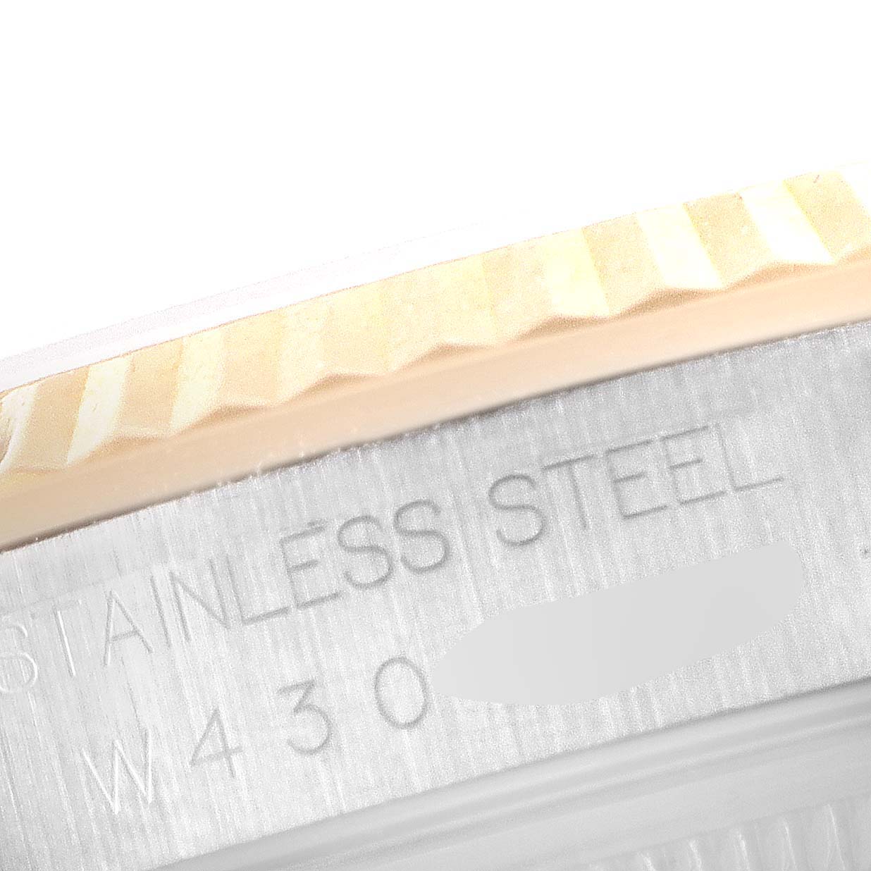 The image shows a close-up of the fluted bezel and the stainless steel side of a Rolex Datejust 16233 Men's Steel and Gold (two tone) Champagne Dial 16233 Men's Steel and Gold (two tone) Champagne Dial watch.