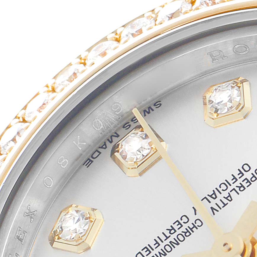 The image focuses on a portion of the Rolex Datejust 179383G Women's Steel and Gold (two tone) Silver Dial 179383G Women's Steel and Gold (two tone) Silver Dial's bezel, dial, and diamond hour markers at a close angle.