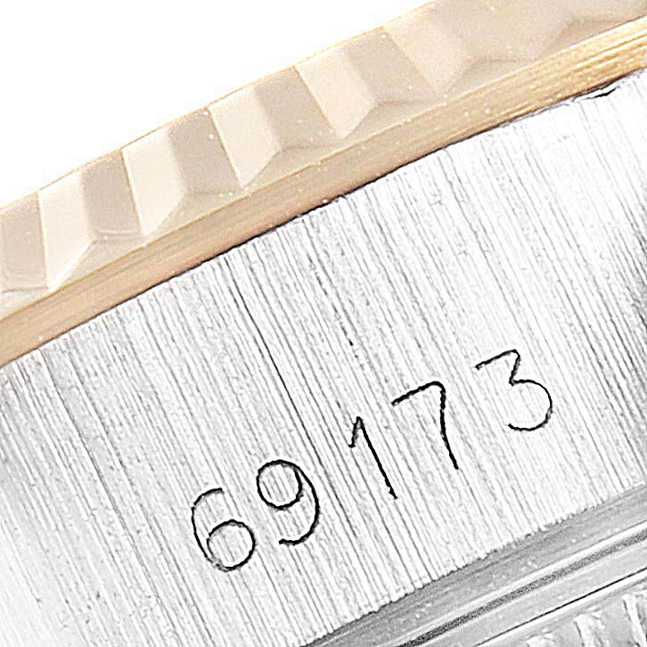 This close-up shows the model number "69173" on the case of a Rolex Datejust 69173  Women
s Steel and Gold (two tone) Champagne Dial 69173  Women
s Steel and Gold (two tone) Champagne Dial watch, along with a part of the bezel.