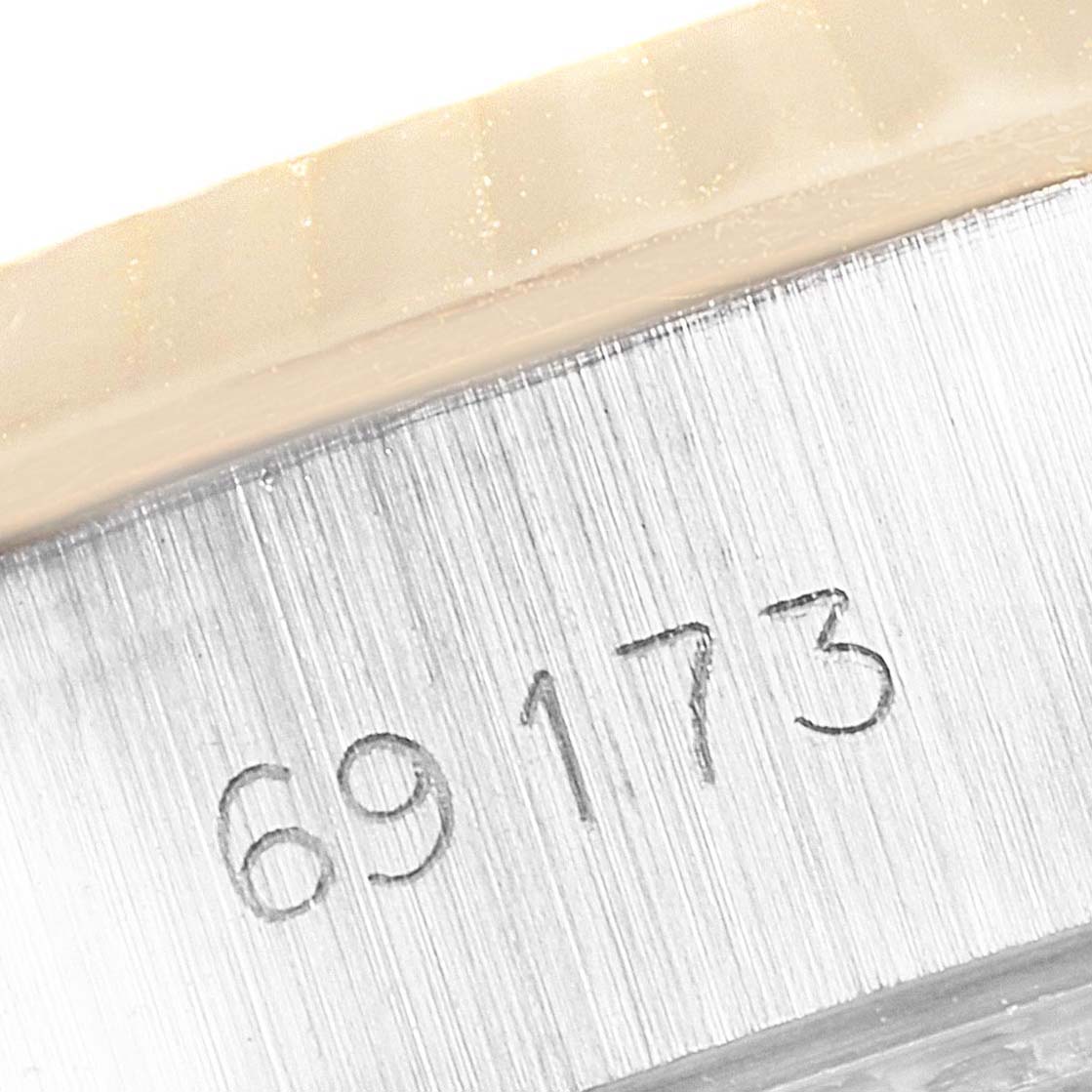 This image shows a close-up of the case side of a Rolex Datejust 69173 Women
s Steel and Gold (two tone) Champagne Dial 69173 Women
s Steel and Gold (two tone) Champagne Dial watch, displaying its model number "69173."