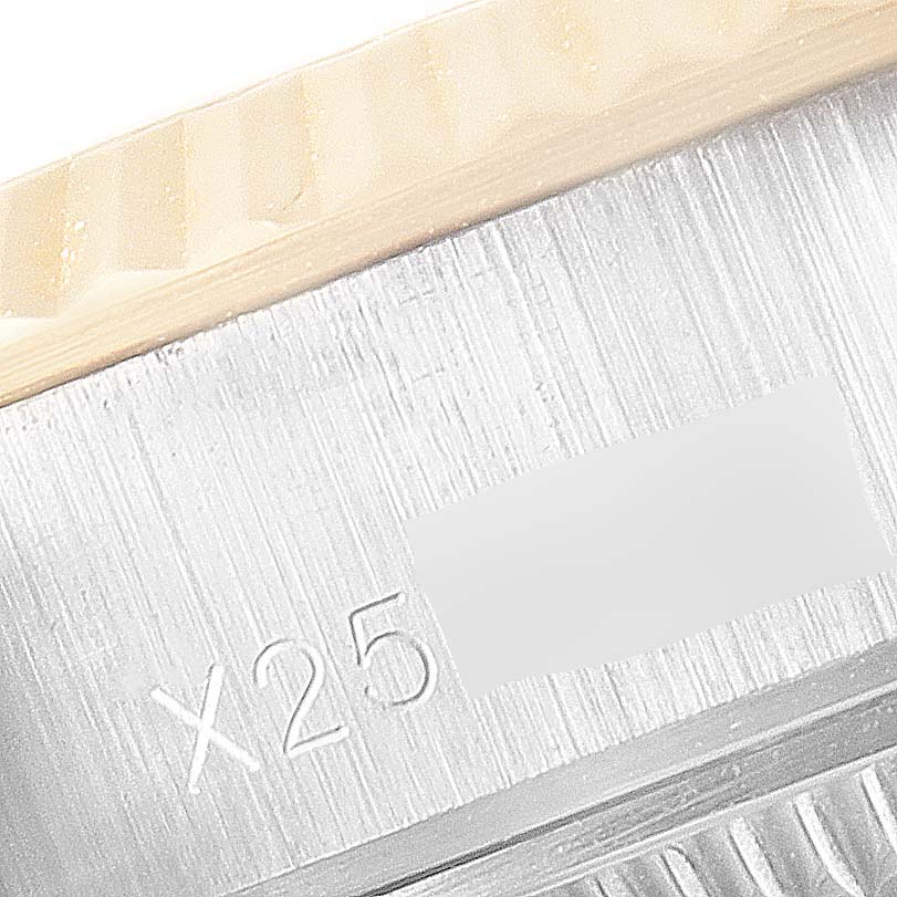 This image shows a close-up view of the fluted bezel and part of the serial number engraving on a Rolex Datejust 69173 Women
s Steel and Gold (two tone) Champagne Dial 69173 Women
s Steel and Gold (two tone) Champagne Dial model watch.